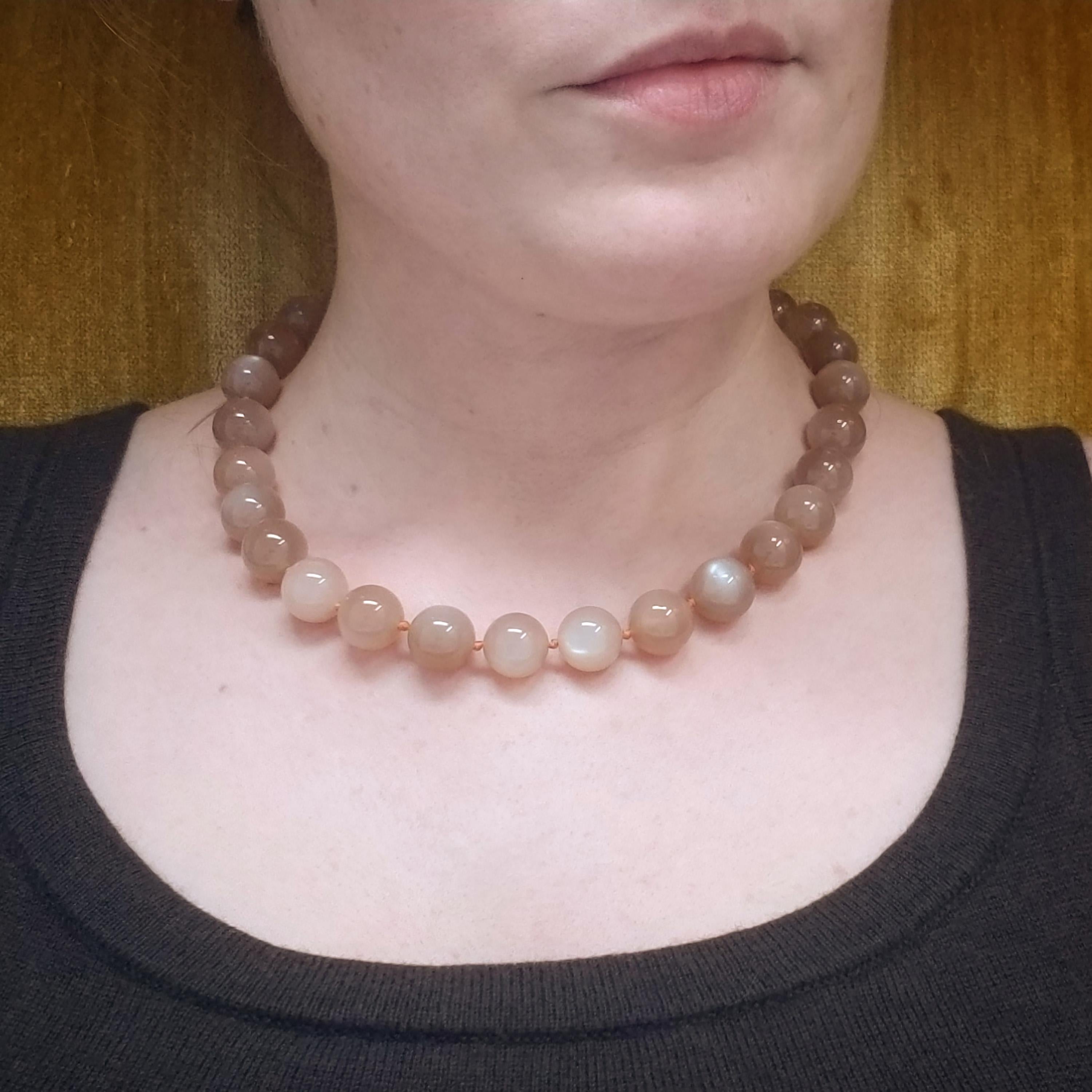 These luxurious peach moonstone beads feature an exceptionally luscious color and exquisite adularescence. This elegant gemstone beaded necklace is destined to be a favorite.

This necklace is finished with our favorite 18kt gold lobster claw clasp.