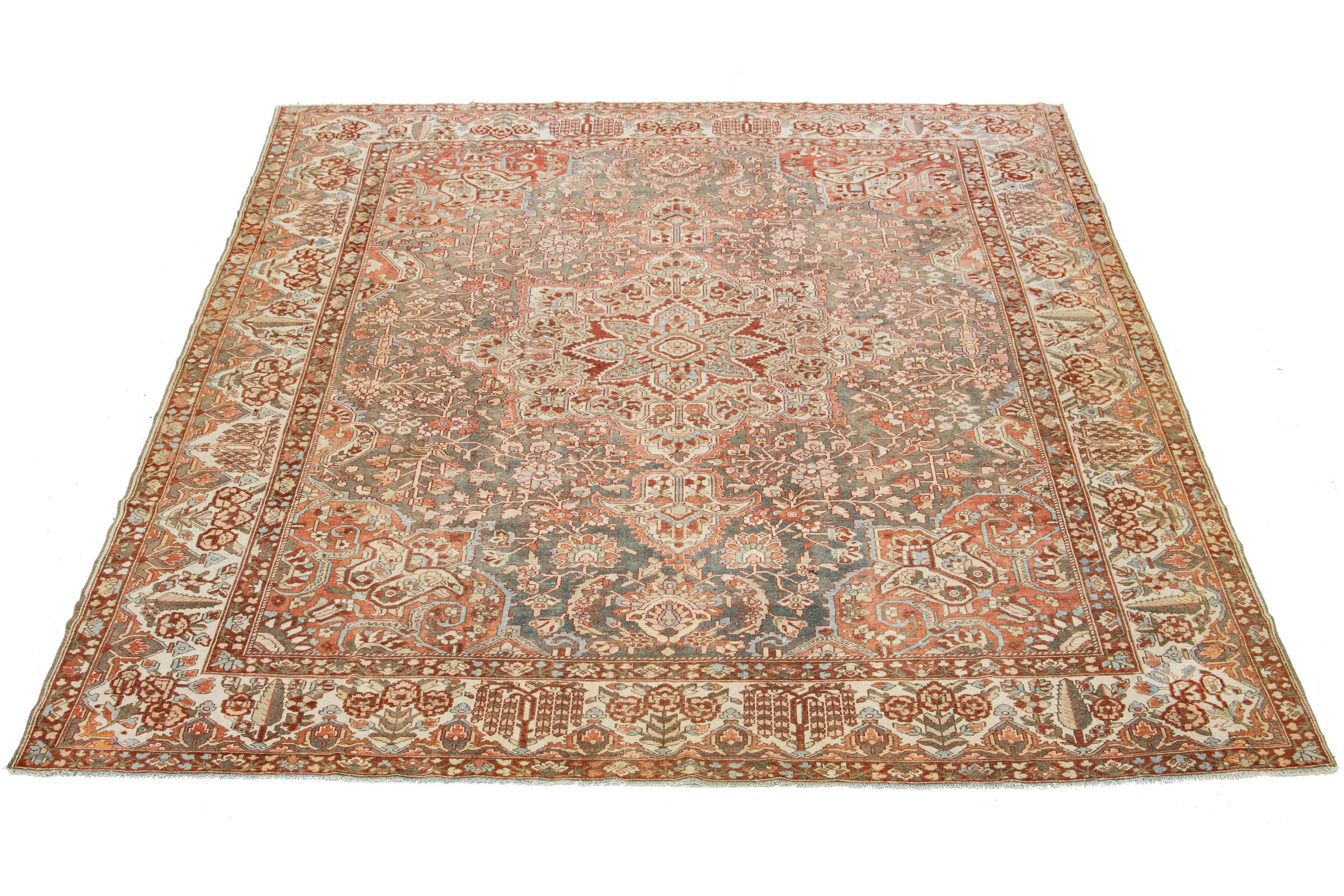 Beautiful Antique Bakhtiari hand-knotted wool rug with a gray color field. This Persian piece has a blue, beige,  red-rust, and peach in a classic medallion floral design.

This rug measures 12'3