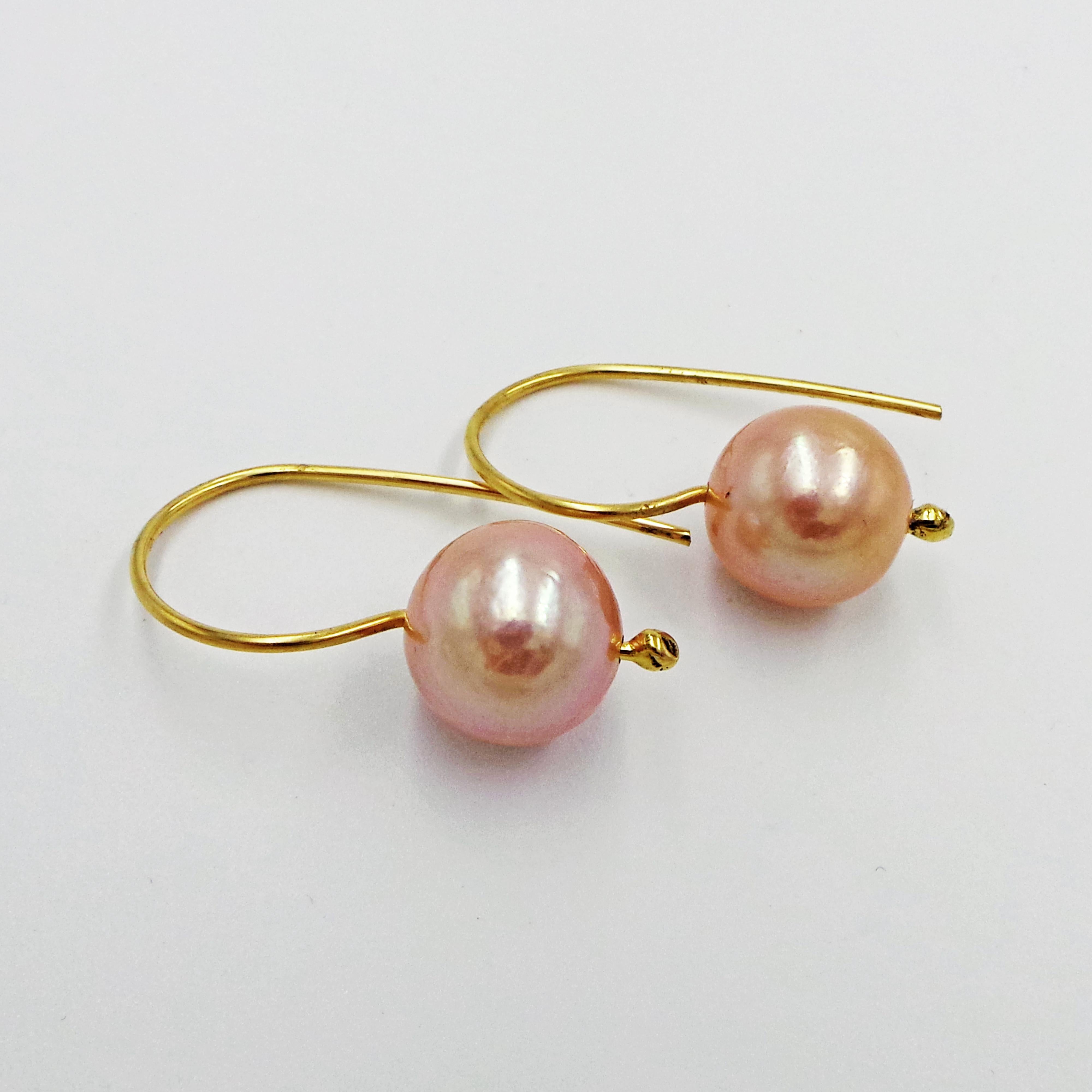 Round, Freshwater Pearls (12.5mm) with peach / pink color on solid 18k yellow gold French wire drop earrings. Perfect for everyday, or to dress up.