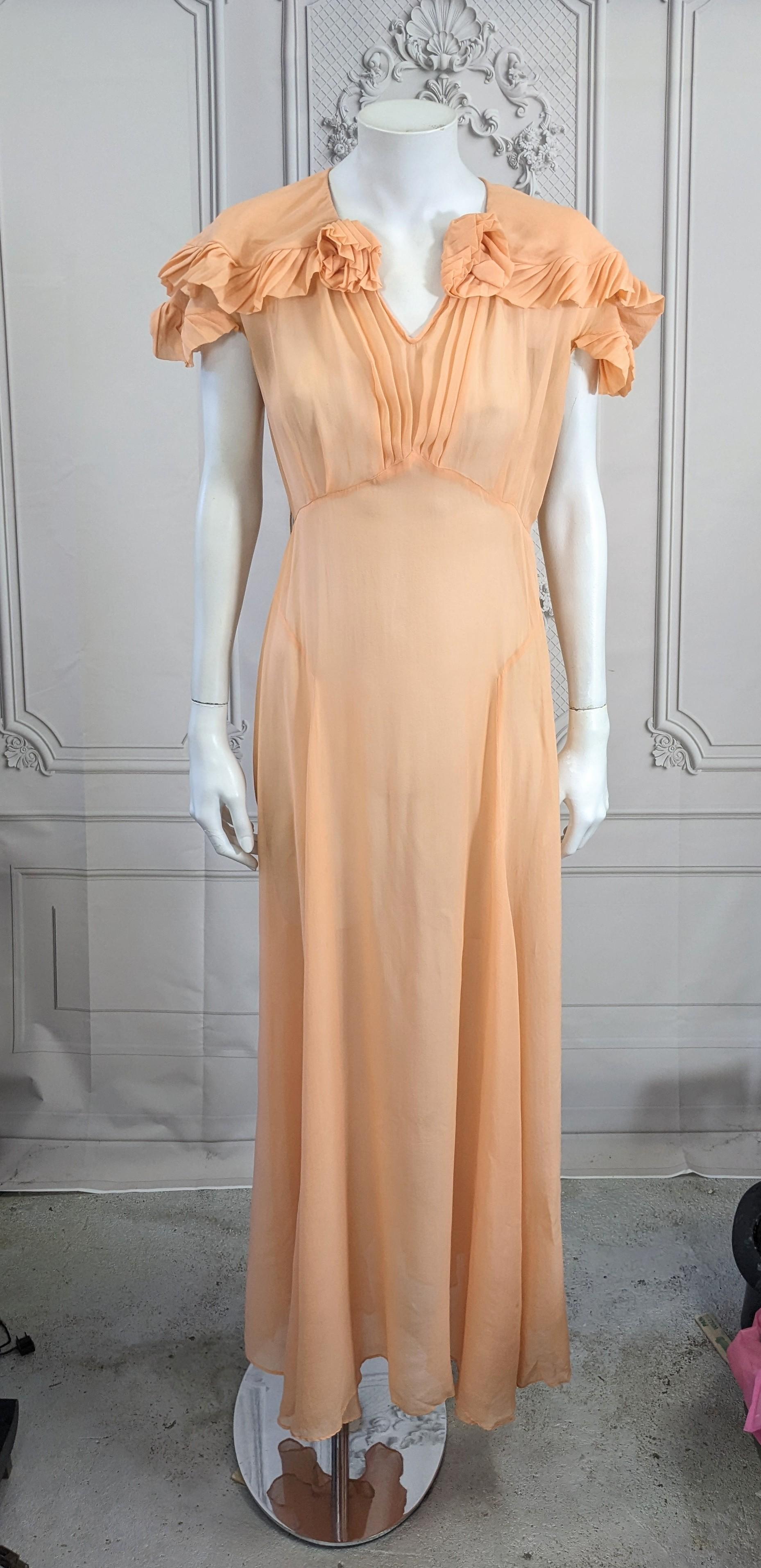 Elegant Peach Silk Chiffon Art Deco Pleated Edge Trimmed Gown from the 1930's. Pleated trim is used to edge the cape collar, sleeves and create neckline flowers. Hook and eye closure at neck with pleated detail down front. Full bias skirt. Gown is