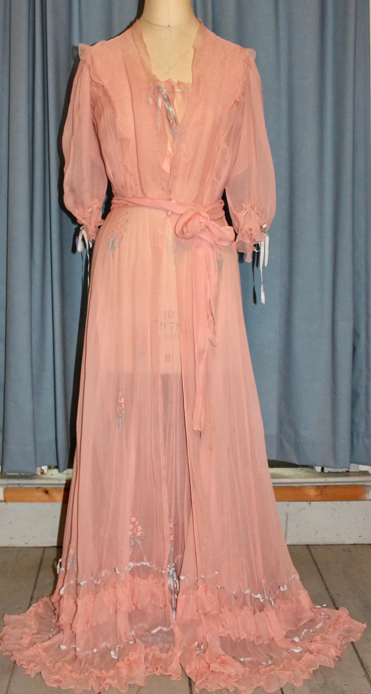 Silk embroidered flowers throughout.  Interlaced ribbons on hems and cuffs.