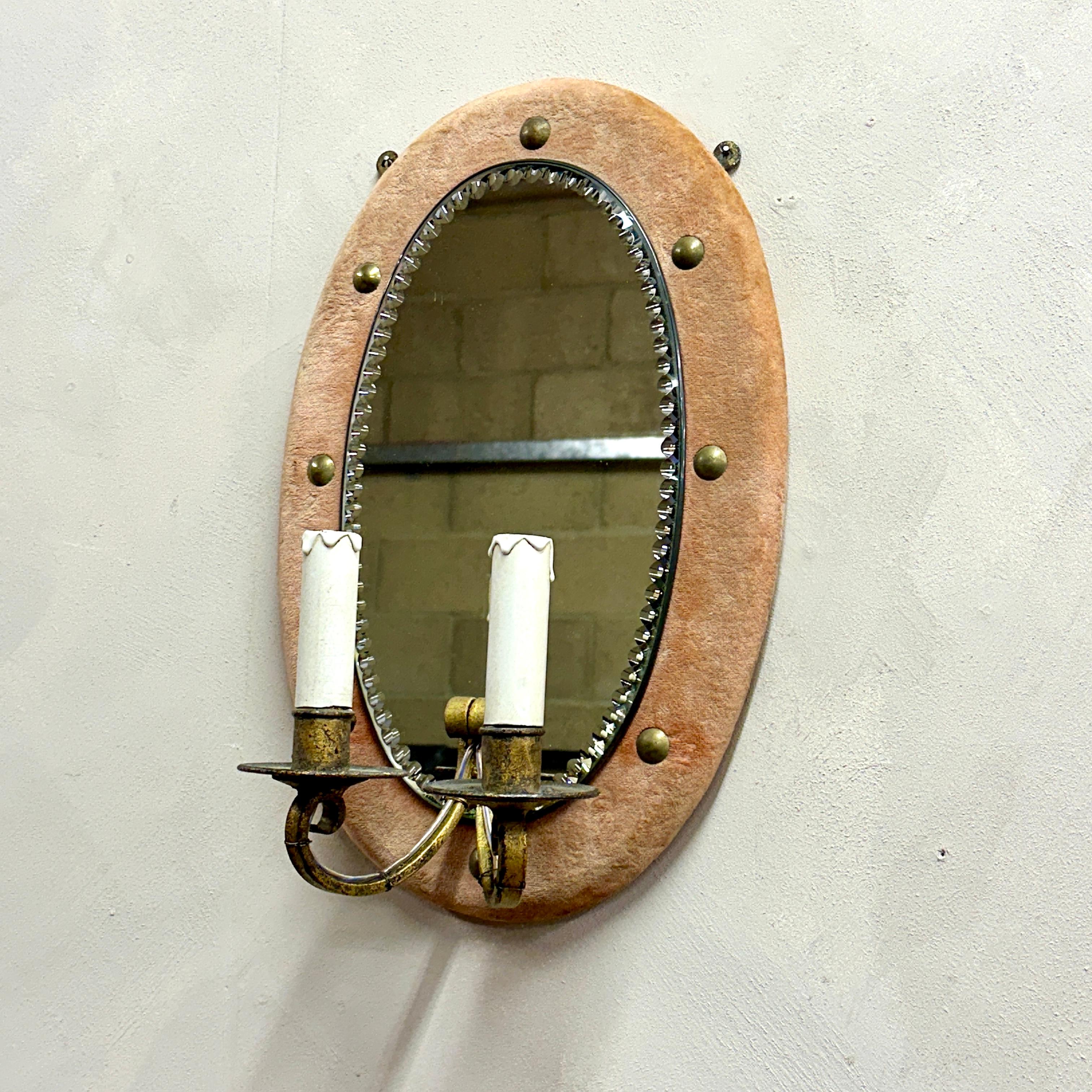 Oval bevelled mirror, cushioned in studded peach velvet.
With double faux candle sconce,  wired, PAT tested and ready to be installed on a wall.

Height: 46cm, Width: 30cm, Depth: 17cm.

Please message if any further info or photos are required 

We