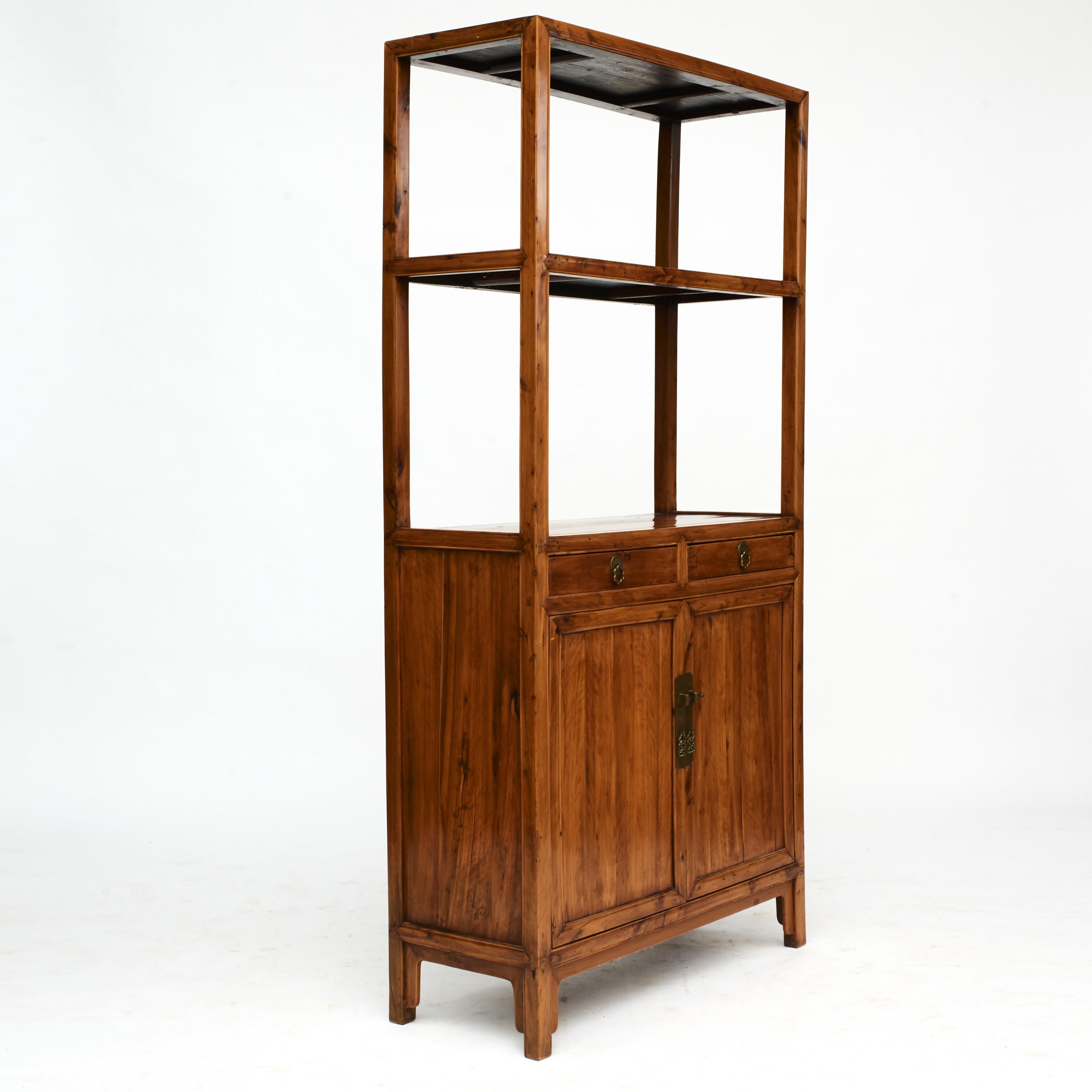 Bookcase made in peach wood. Pair of doors, 2 drawers and 2 shelves.
From Jiangsu Province 1840-1860.

Peach is a beautiful type of wood with warm undertones and lovely grain. Furnitures made in peach wood is relatively rare.
  