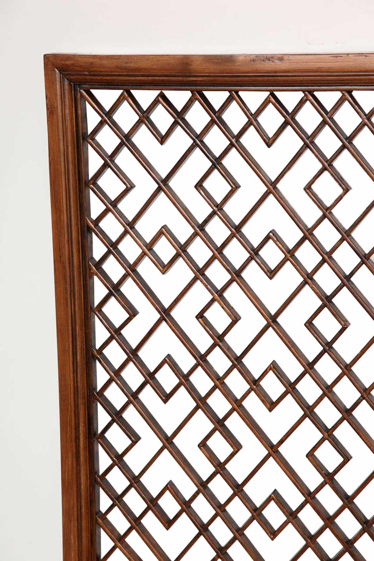 A wood lattice screen or wall panel in a traditional Chinese pattern. Shanghai, circa 1925. Traditional diagonal pattern.
