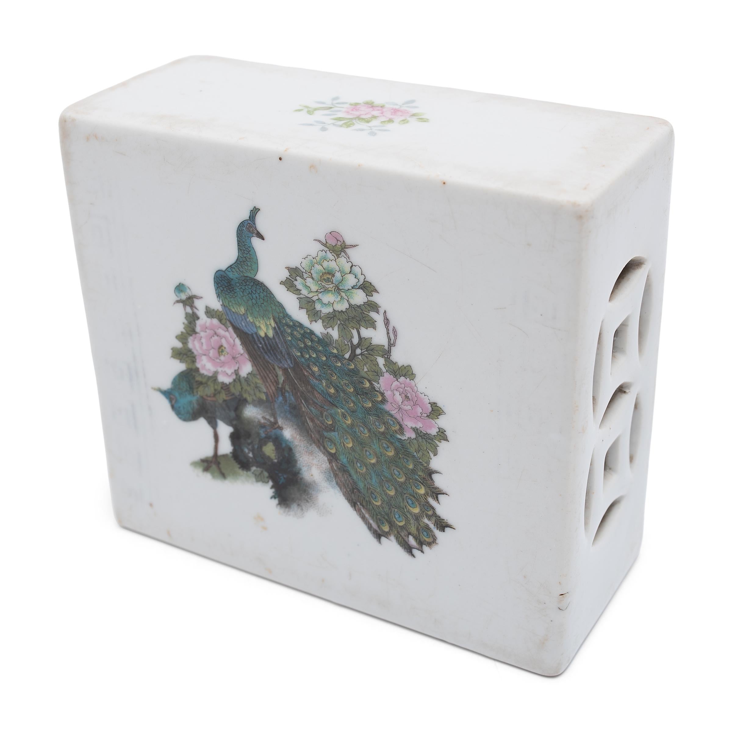 This square ceramic block is actually a form of Chinese headrest or neck pillow. Popular during the Qing dynasty, rigid headrests such as this were used by upper-class women to protect their elaborate hairstyles by elevating the head during slumber.