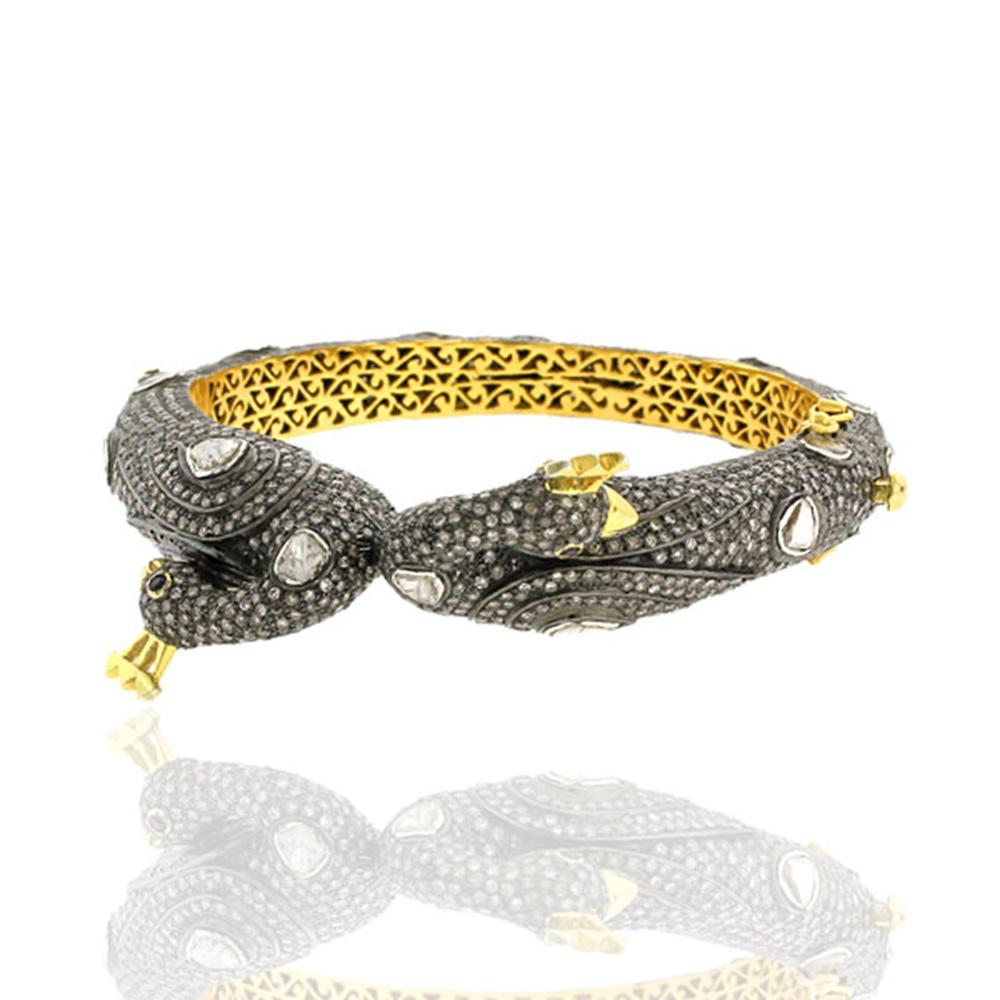 Phenomenal in every way this Peacock Bangle set with pave diamonds and rose cut diamonds is ethnic looking which can be worn with any floral dress or shirt to rock it. This bangle opens on side and has box and safety clasps.

14k: 11.8g
Diamond: