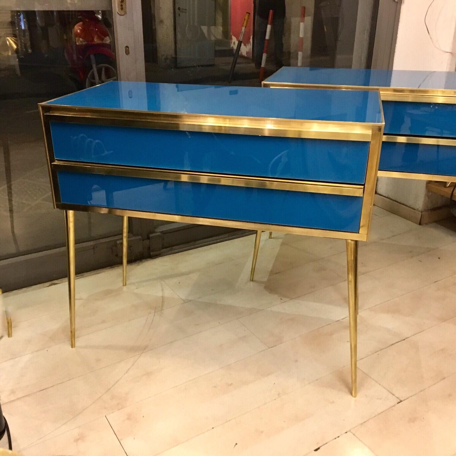 Peacock blue opaline glass chest of drawers, two drawers, brass legs and fittings. Available the pair, they can be used as nightstands.
 