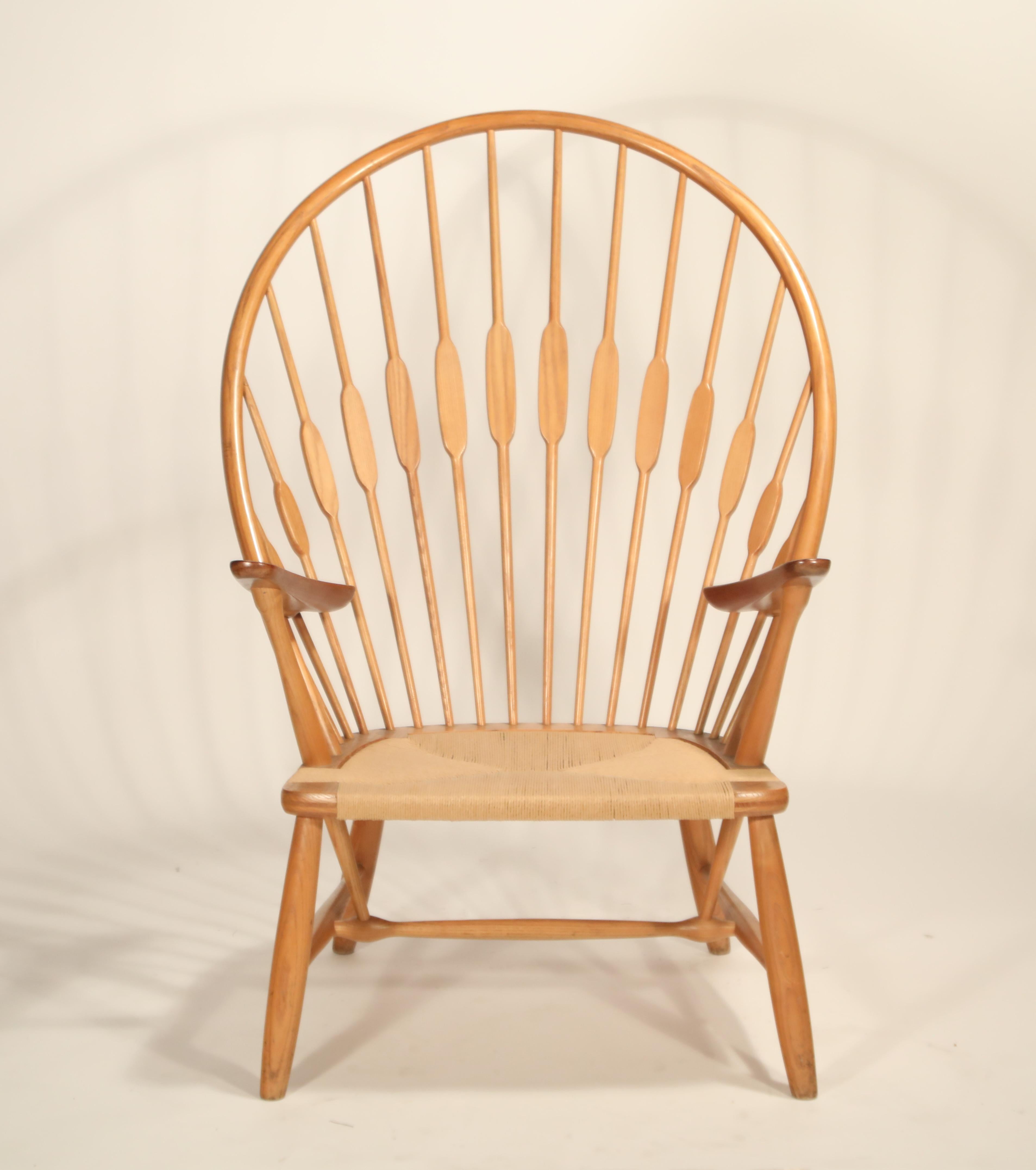 This extremely well-cared-for peacock chair by Hans Wegner came from a single family owner, and while has some minor aging, is in amazing original condition considering its age. Crafted by cabinet maker Johannes Hansen, this Peacock armchair is an