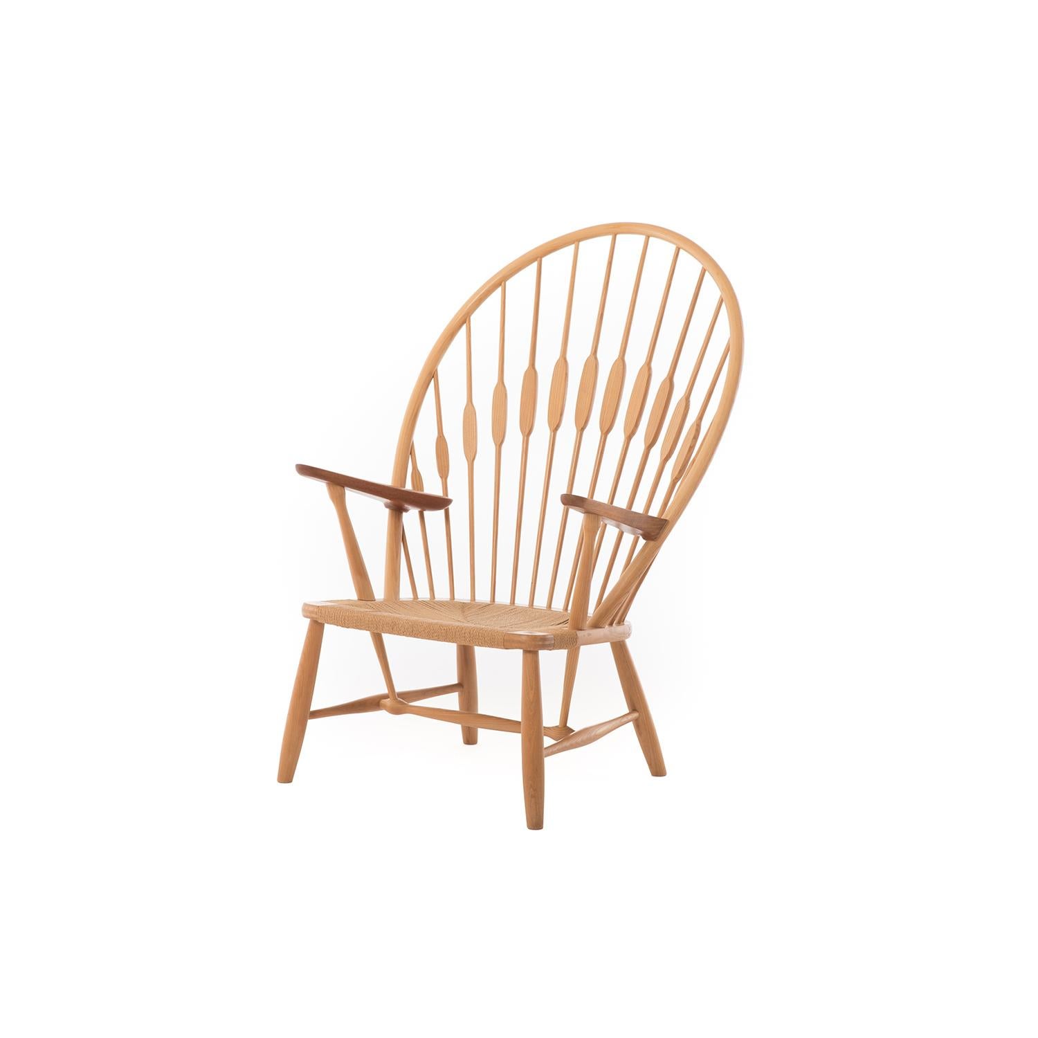 An iconic design by Hans J Wegner, this lounge makes a statement in any environment. In teak and ash with original Danish cord seat. This piece comes with leather seat pad. Seat height is 14