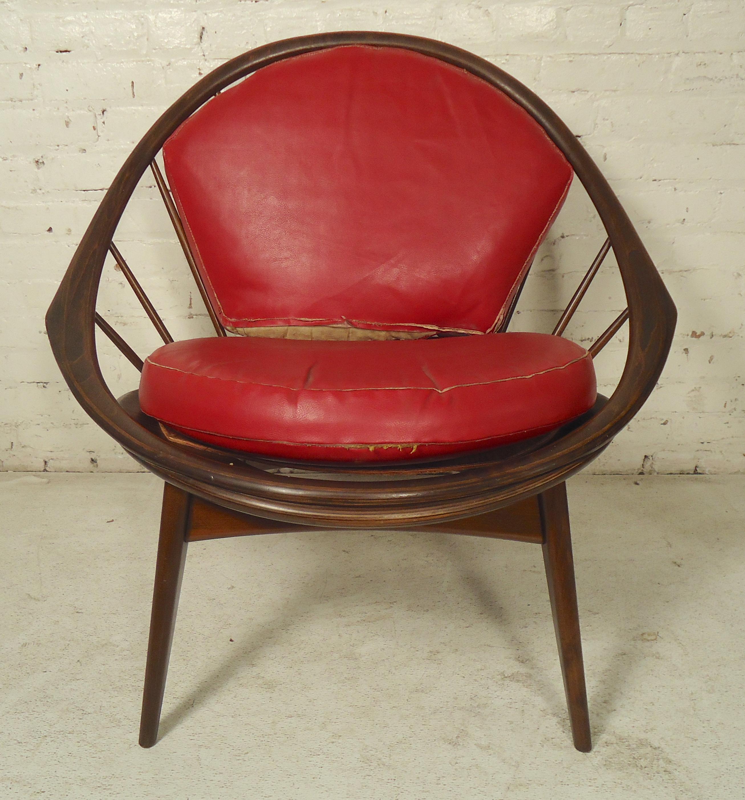 Ib Kofod-Larsen for Selig Hoop peacock chair. Spindle back with sculpted wood frame.
(Please confirm item location - NY or NJ - with dealer).
         