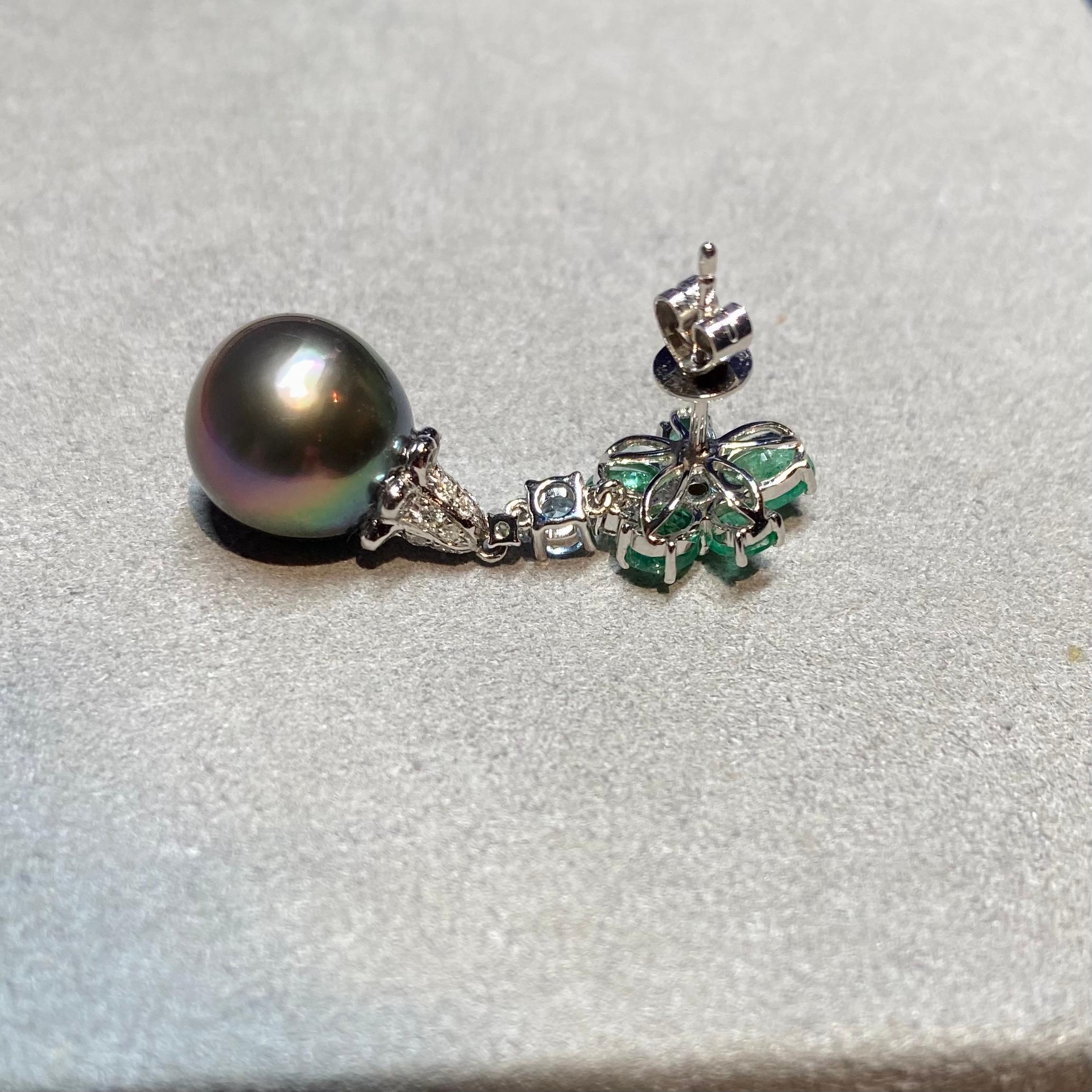 A pair of  Tahitian Pearls, Emerald and Diamond Earring in 18k White Gold
It consists of A pair drop Shape Tahitian Pearl with Good Lustre and very little Spotted Surface 
The Colour of the Pearls are Peacock Black with Pink and Green Overtone
The