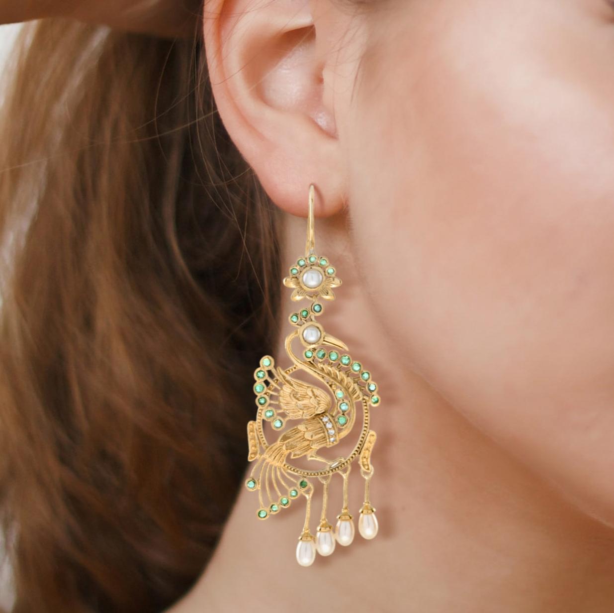 Let these beautiful birds bring you joy in more way than one. The peacock represents happiness. Dangle our Peacock Earrings from your lobes as exotic statement pieces. These detailed and layered earrings are in 14k yellow gold. The earrings feature