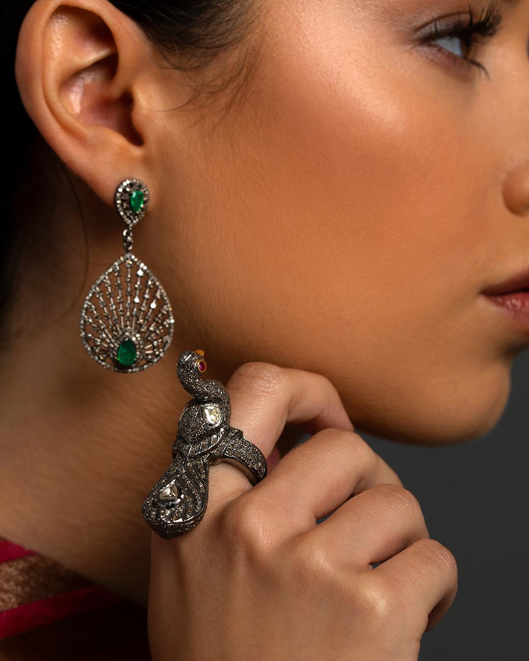 One of our favourite pair of earrings! Very elegant, classic and conversation starter! Set with single cut pave diamonds and emeralds, on 925 oxidized silver to give an old feel and ear backs all in 14 kt gold.

1.99 carat emeralds; 2.39 carat