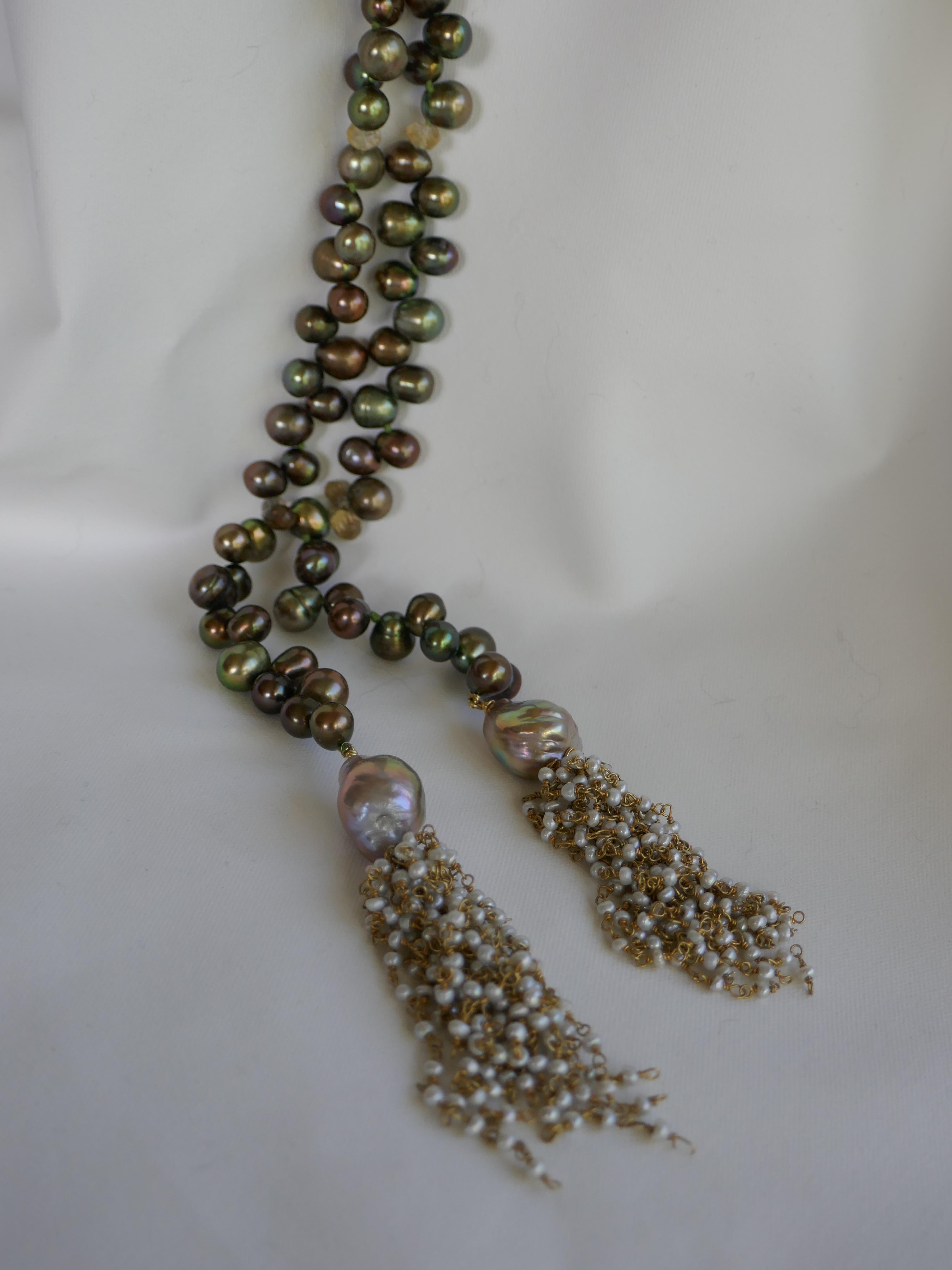 The drop cultured pearls in this necklace are peacock green in color and finished with a keshi pearl vermeil sterling silver chain tassel, and baroque cultured pearls.  Citrine roundels are interspersed throughout the necklace. The drop cultured