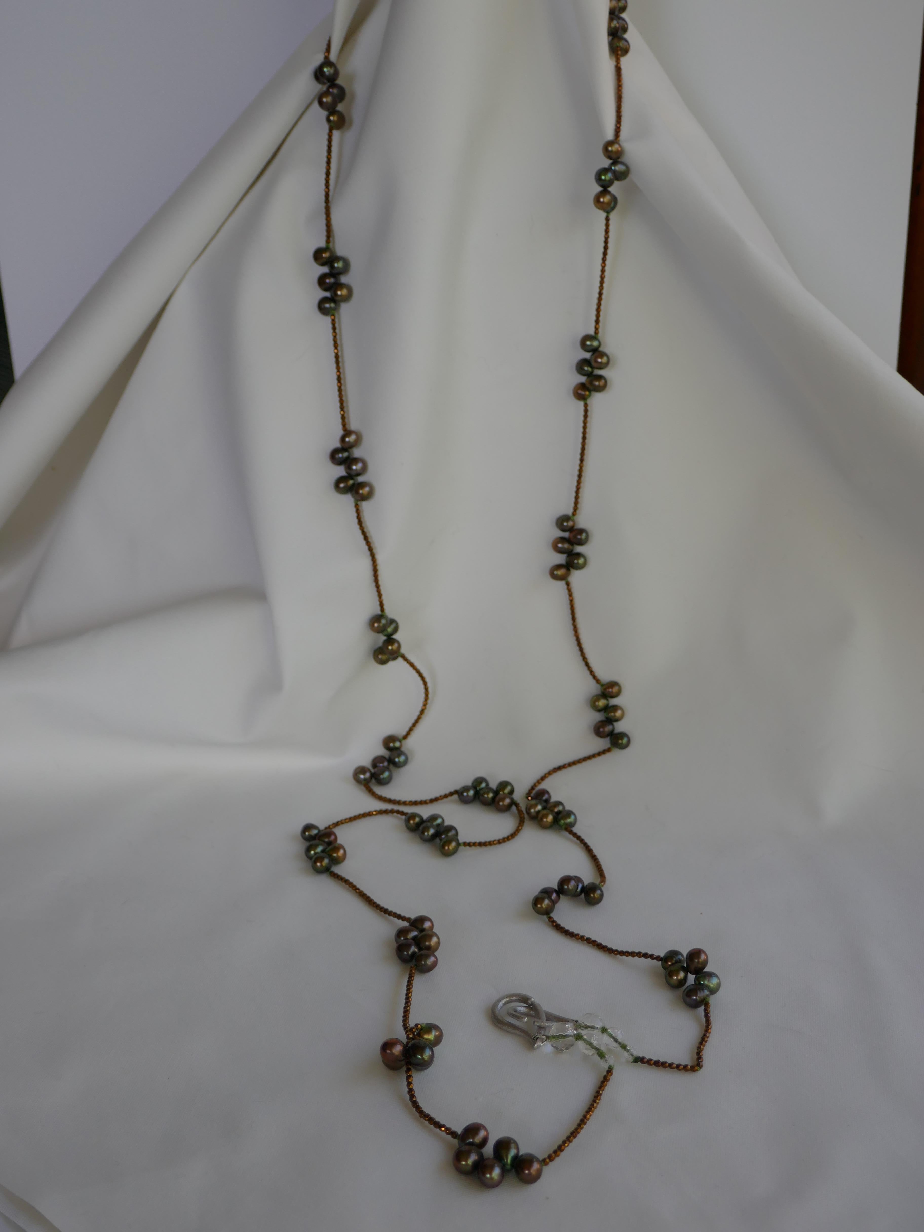 This necklace is made of 2mm copper plated hematite beads and 8-8.5mm peacock green drop cultured pearls. It is finished with rock crystal and a 925 sterling silver clasp.  This is my six in one necklace as shown on the photographs. It is very