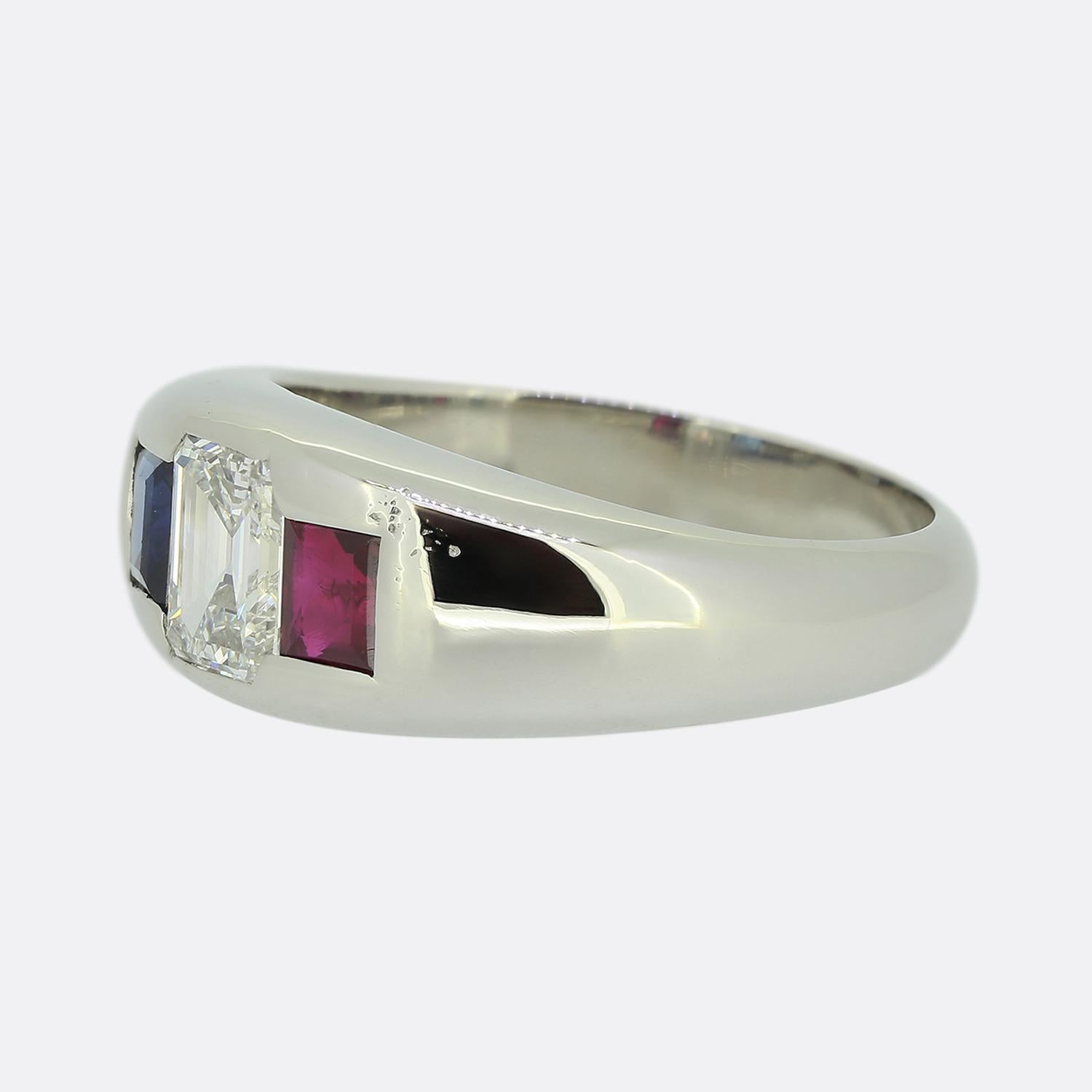 Here we have an outstanding three-stone ring from the renowned Chicago IL based jeweller, J.W Peacock. This piece has been crafted from platinum and showcases a fabulous trio of precious gemstones. A bright white 1.10ct emerald cut diamond sits at
