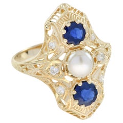 Anello a tre pietre con diamante e zaffiro blu in stile antico in filigrana d'oro 9K