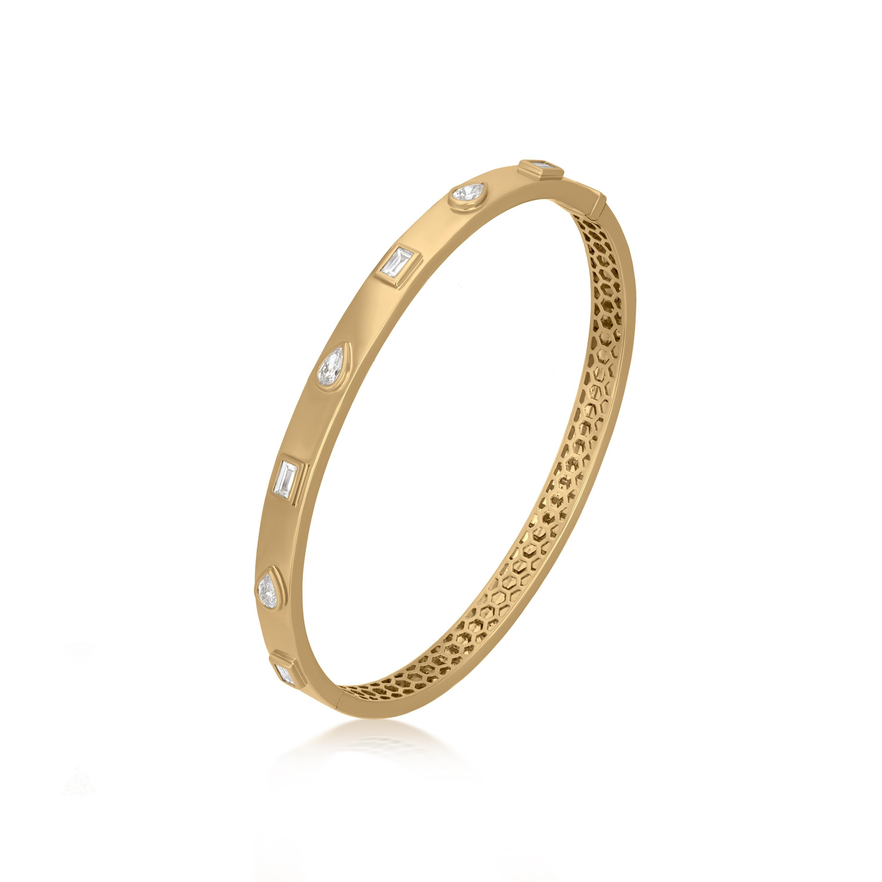 This hinged bangle adds a surreal charm to your wrist. Set in 18K Yellow Gold by Luxle, this modern bangle is gracefully adorned with baguette and pear-shaped full-cut shining white diamonds in a bezel setting. The diamonds weigh 0.76 cwt, making