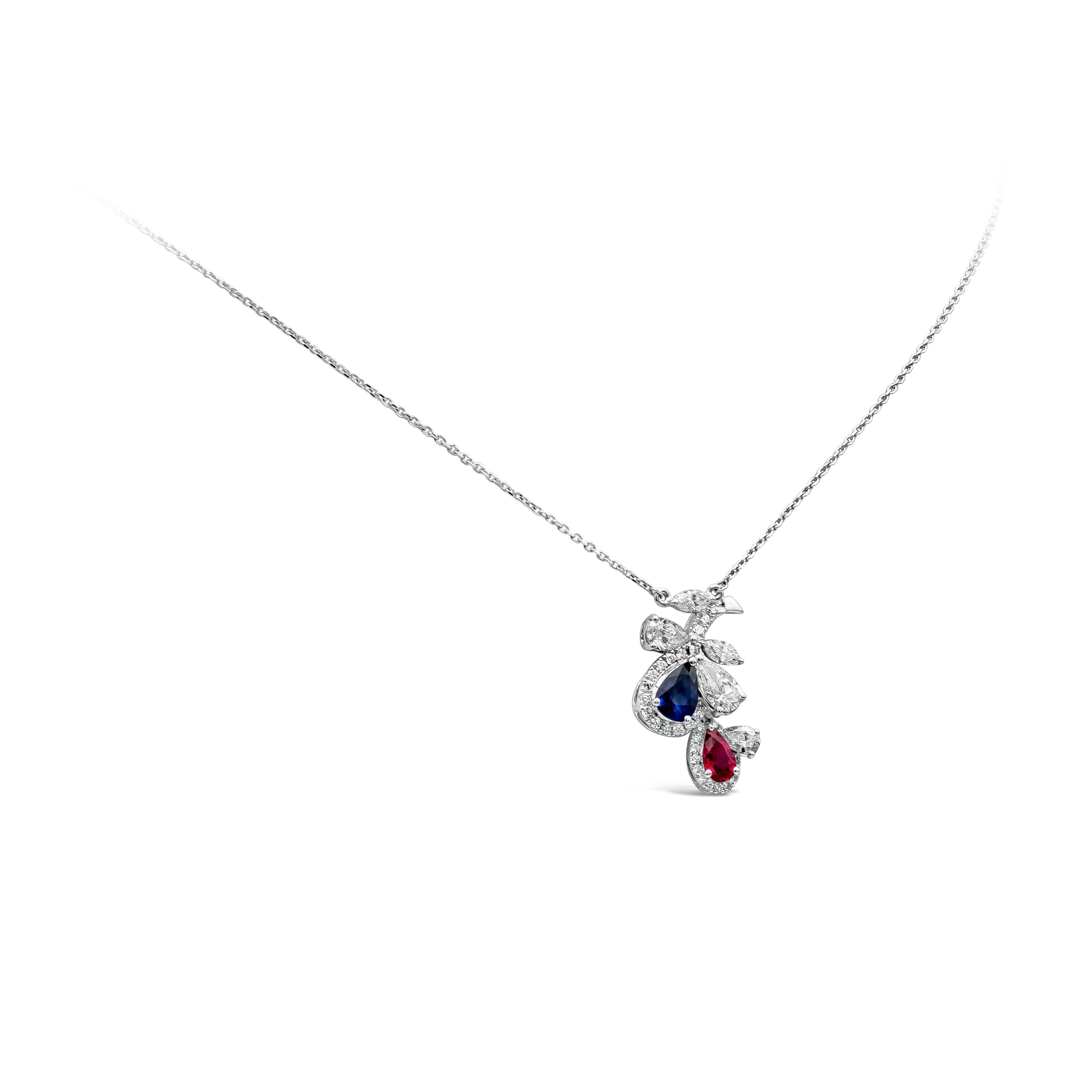 A gorgeous necklace featuring a pear and marquise cut diamond, blue sapphires and red rubies in pear shape set in a flower. The flower is set with a pear and marquise cut diamond that weighs about 0.70 carat total, approximately FG color, VS