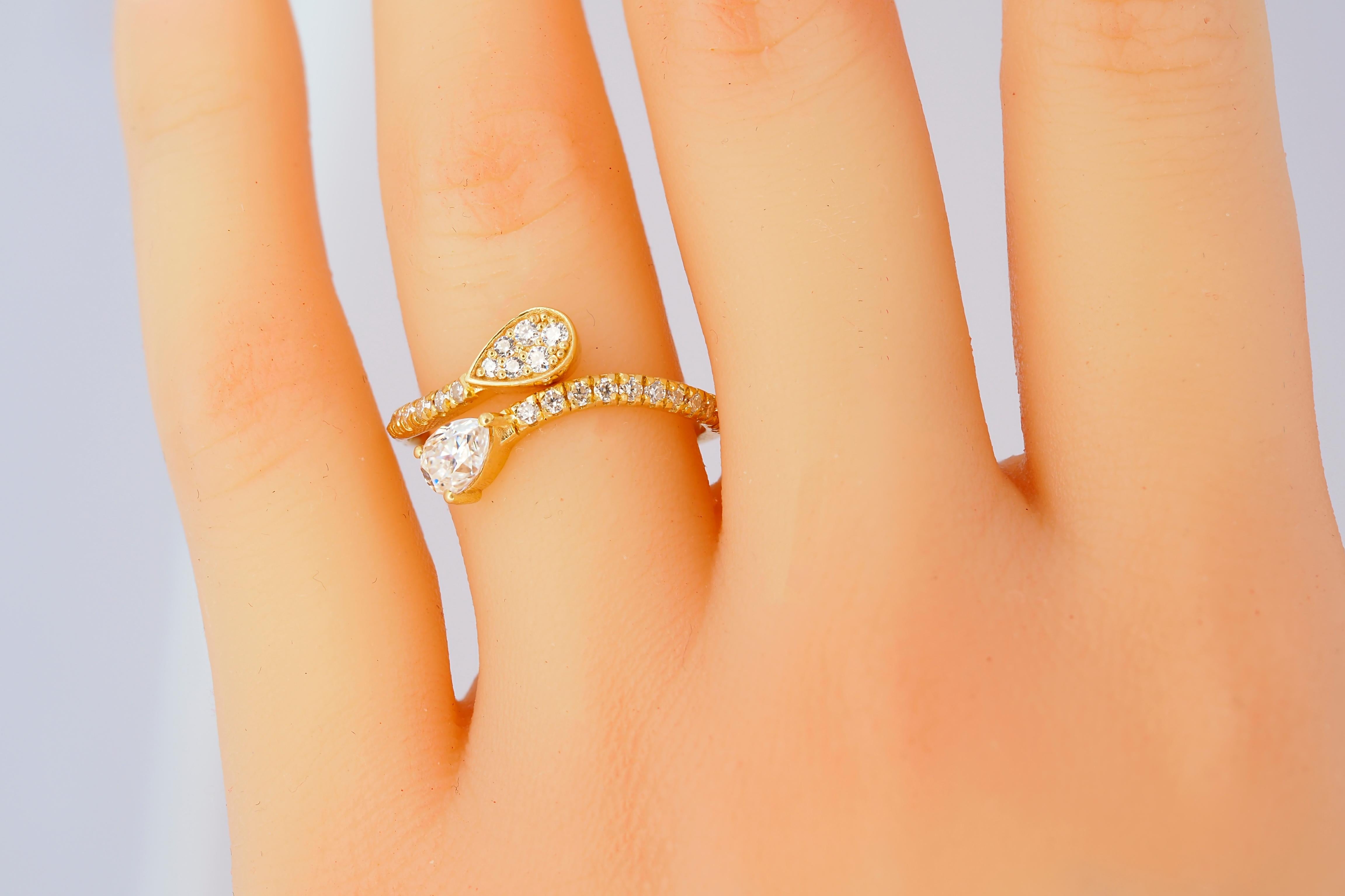 For Sale:  Pear and round diamond cut moissanite open ended 14k gold ring.  8