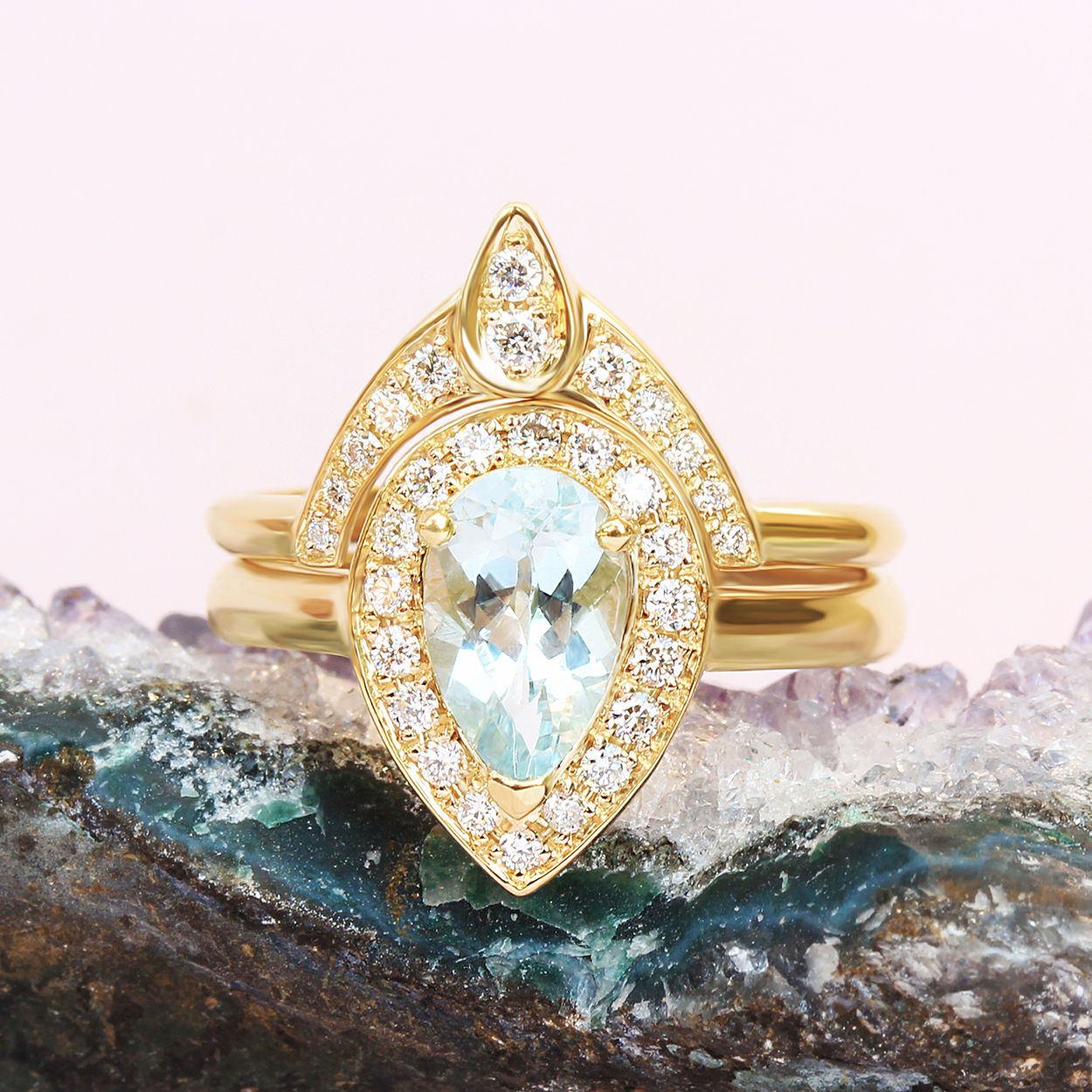 Pear Aquamarine Diamond Halo Ring Bridal Set.
* This list is for a two ring set.
Handmade with care. 
An original design by Silly Shiny Diamonds. 

Details: 
* Center Stone Shape: Pear shape. 
* Center Stone Type: light blue Aquamarine 0.70 carat.