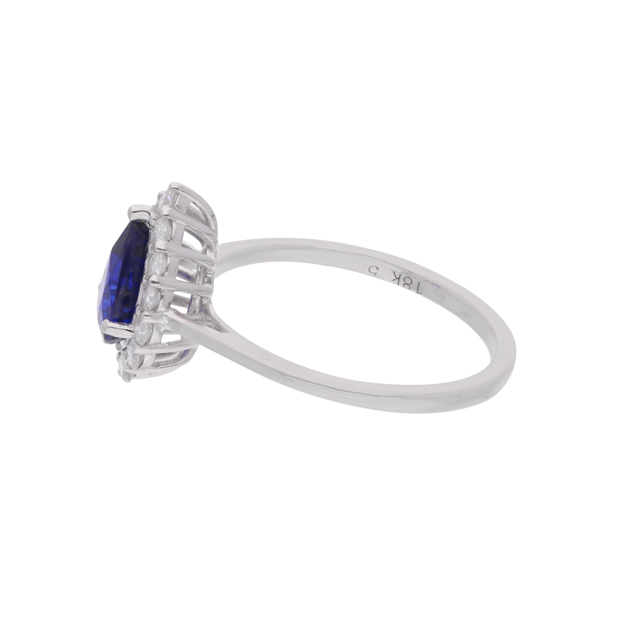 Experience the epitome of elegance and sophistication with this exquisite handmade ring, featuring a stunning pear-shaped blue sapphire gemstone, complemented by sparkling diamonds and set in luxurious 18 karat white gold. This piece of fine jewelry