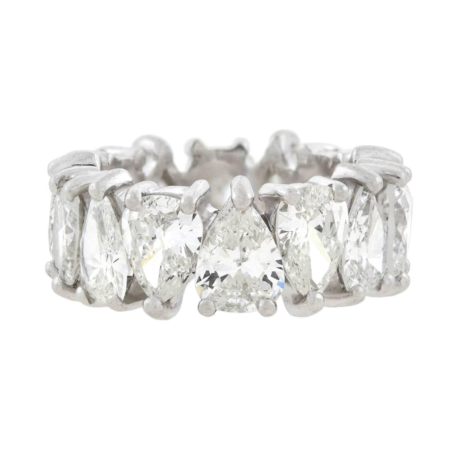 An absolutely fabulous Vintage eternity band from the 1960s era! Crafted in platinum, this unusual and gorgeous ring features fourteen pear-shaped Brilliant Cut diamonds which alternate in direction as they encircle the entire length of the band.