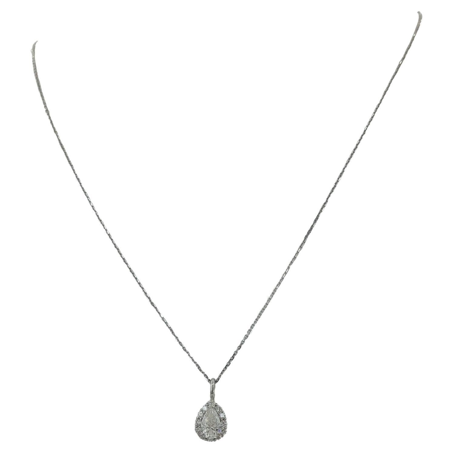 A 14K white gold pear brilliant-cut diamond halo pendant/necklace with a total weight of 1.01 carats is presented on an 18-inch chain. The pendant, including the chain, weighs 2.8 grams, and its dimensions are 10.3 mm long (14.9 mm with bail) and