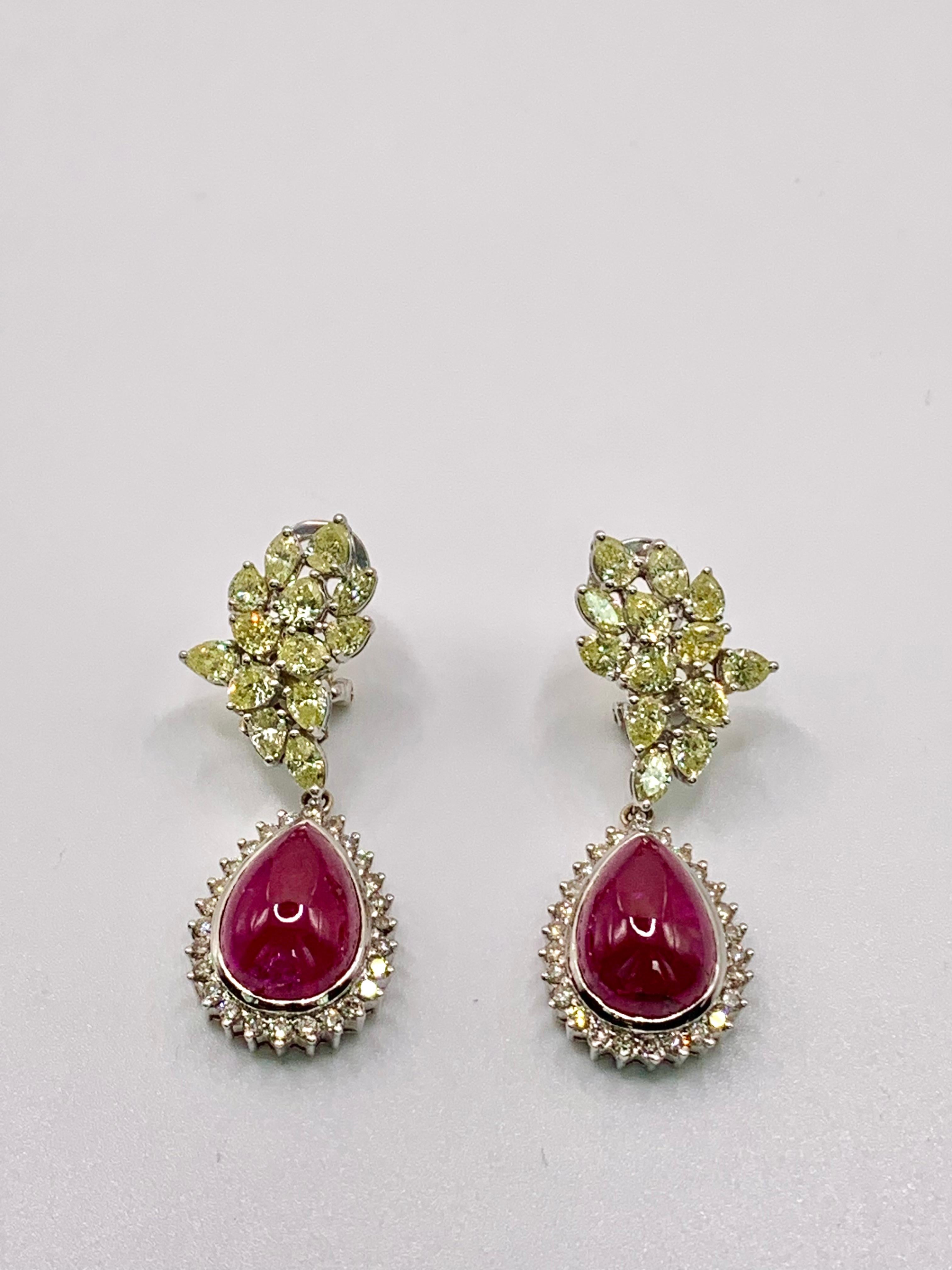 Modern classic style long earrings with pear-cabochon cut Burma rubies and light yellow diamonds and a border of brilliant-cut white diamonds.Made 18K white gold. Demountable.

Product Details
↣ Jewelry Type - Earrings
↣ Style - Modern classic
↣