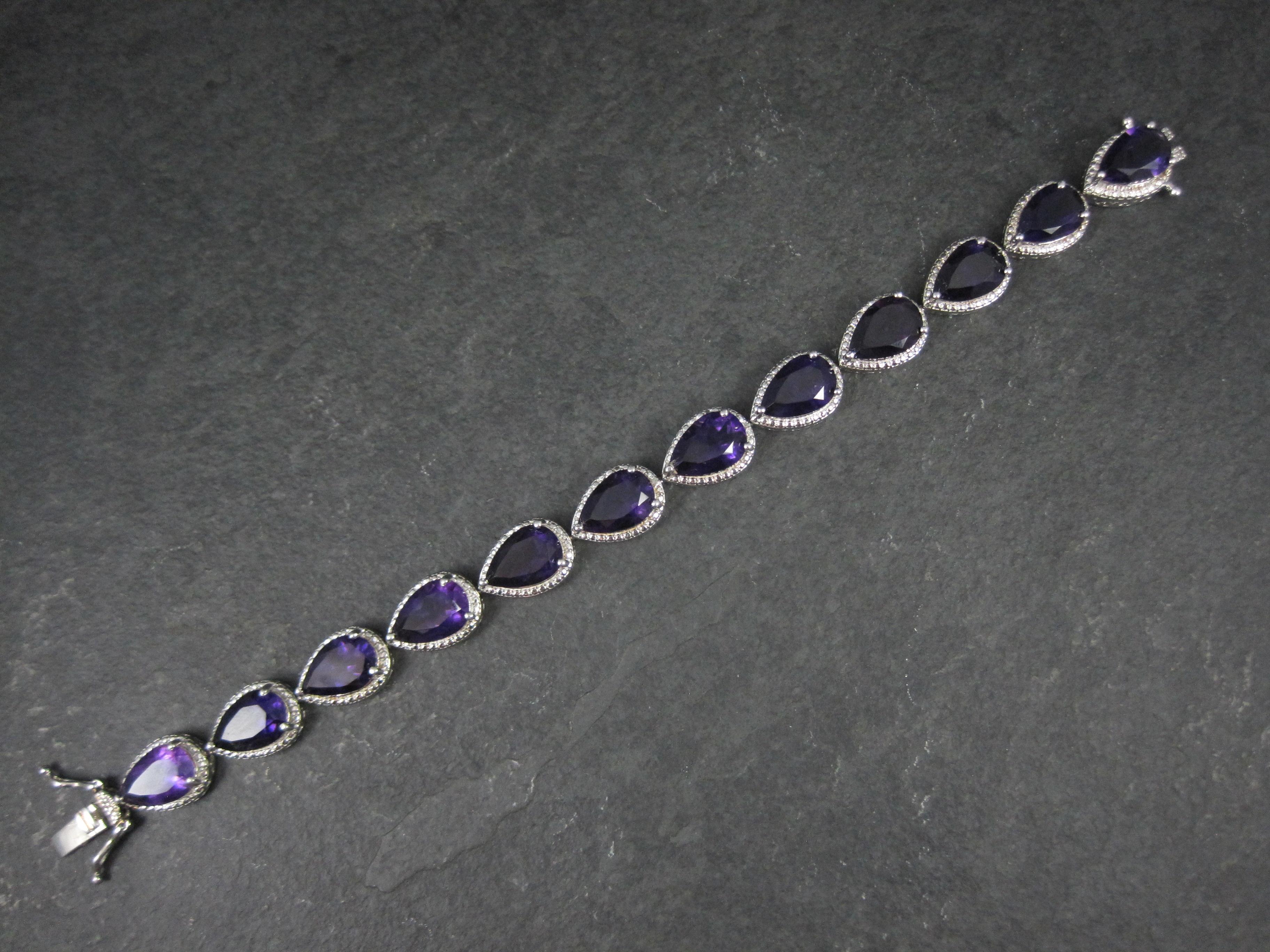 This gorgeous bracelet is sterling silver.
It features an estimated 32.4 carats in 12 pear cut, 12x8mm amethyst gemstones.

This bracelet measures 7/16 of an inch wide and is 7 1/4 wearable inches.
Weight: 23.3 grams

Marks: 925, Chuck Clemency's