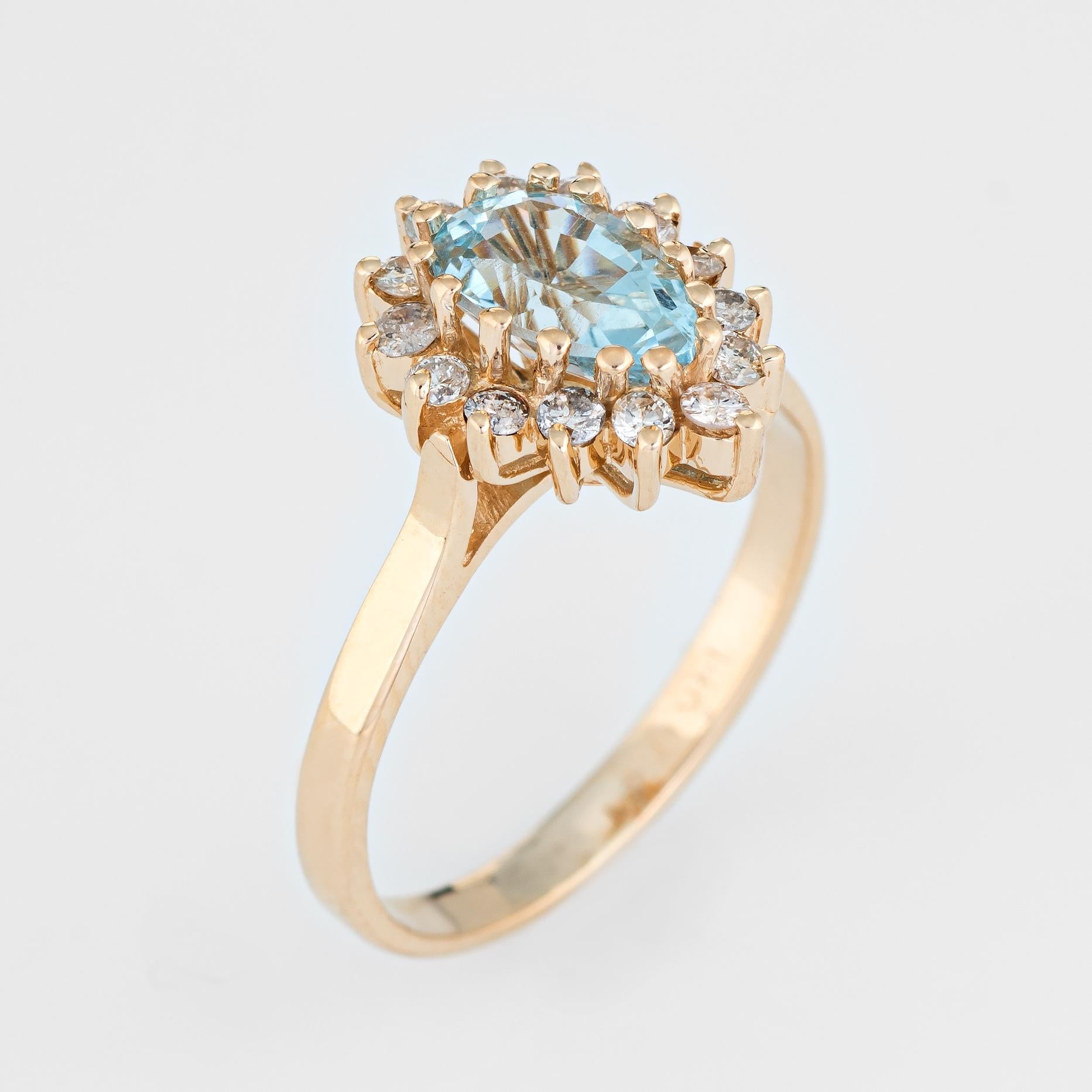 Finely detailed pear cut aquamarine & diamond cocktail ring, crafted in 14 karat yellow gold. 

Pear cut faceted aquamarine measures 7mm x 5mm (estimated at 1 carat), accented with 14 estimated 0.02 carat round brilliant cut diamonds. The total