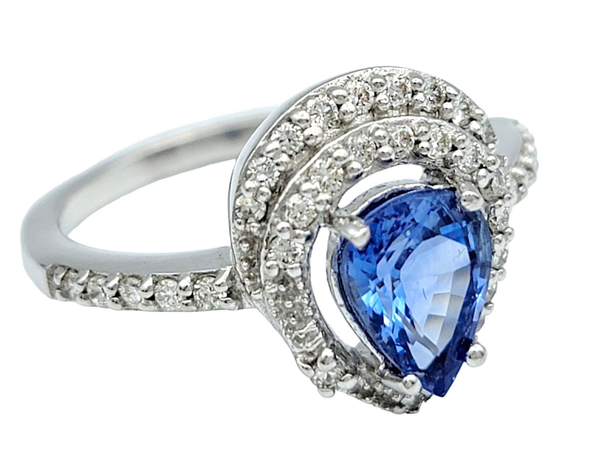 Ring Size: 7

This captivating blue pear-cut Ceylon sapphire ring is adorned with a halo of sparkling diamonds, all elegantly set in lustrous 18 karat white gold. The mesmerizing hue of the Ceylon sapphire is accentuated by the brilliance of the