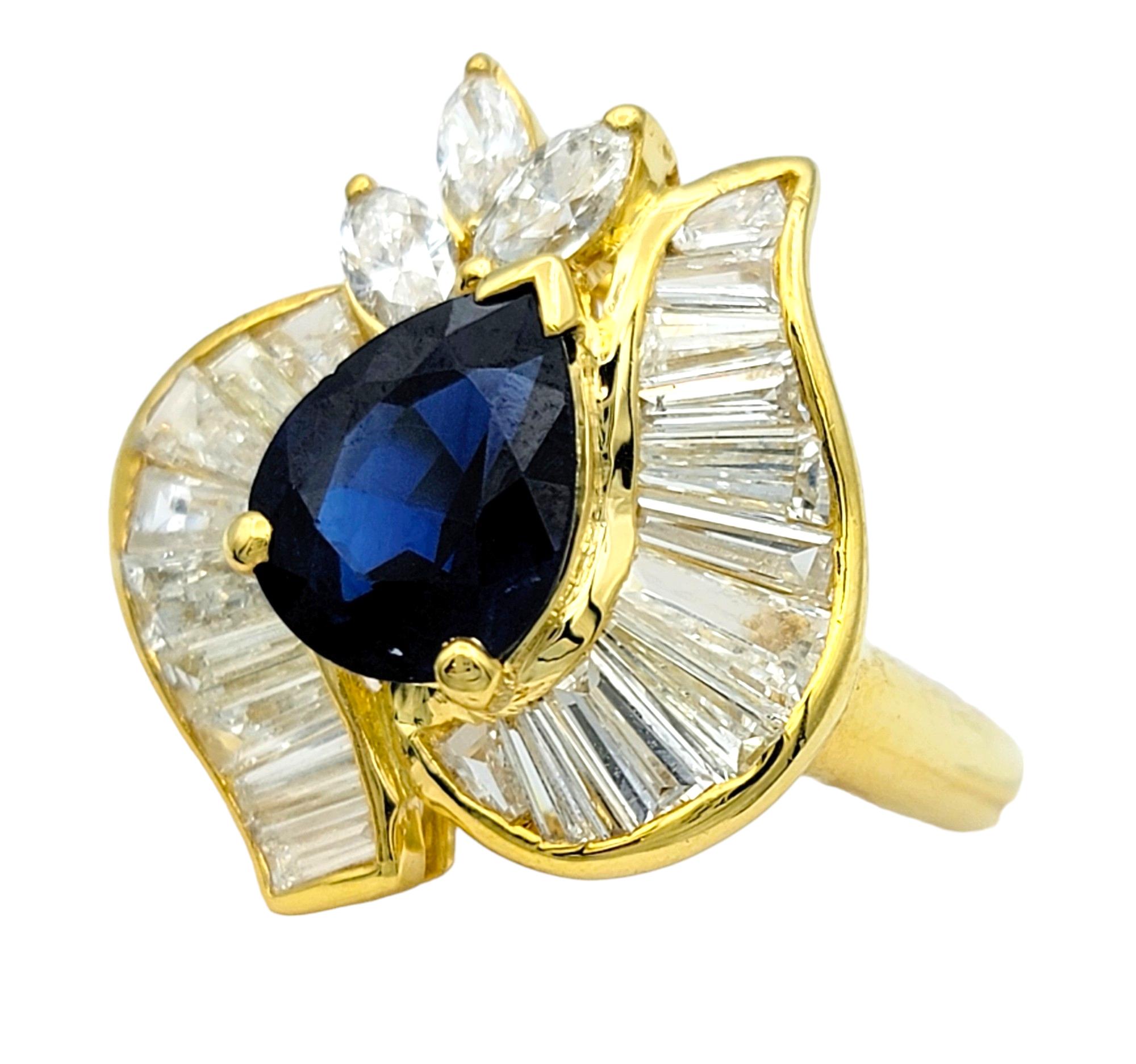 Contemporary Pear Cut Blue Sapphire Ring with Baguette and Marquise Diamonds in 18 Karat Gold