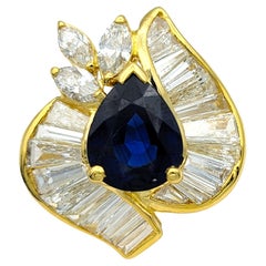 Pear Cut Blue Sapphire Ring with Baguette and Marquise Diamonds in 18 Karat Gold