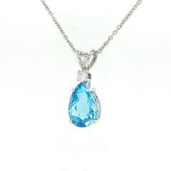Pear cut blue topaz and diamond pendant