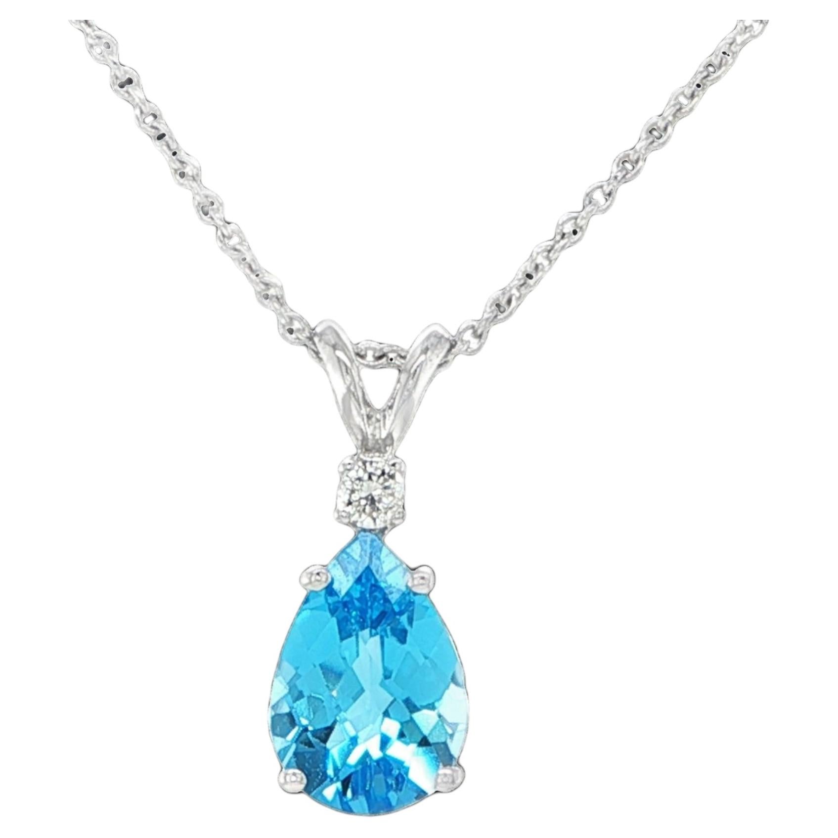 Colgante de topacio azul talla pera y diamante