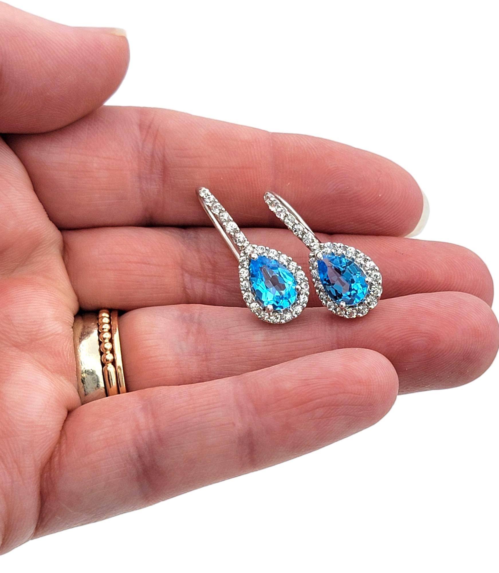 Pear Cut Blue Topaz and White Sapphire Halo Drop Earrings in 14 Karat White Gold For Sale 2