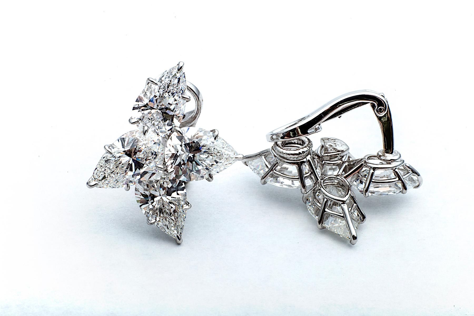 Two clusters of four bewitchingly brilliant pear cut diamonds create this pair of dazzling floral heirloom earrings that are guaranteed to eternally bloom for you.  Mounted in a handmade platinum clip setting, the perfectly matched diamond floral