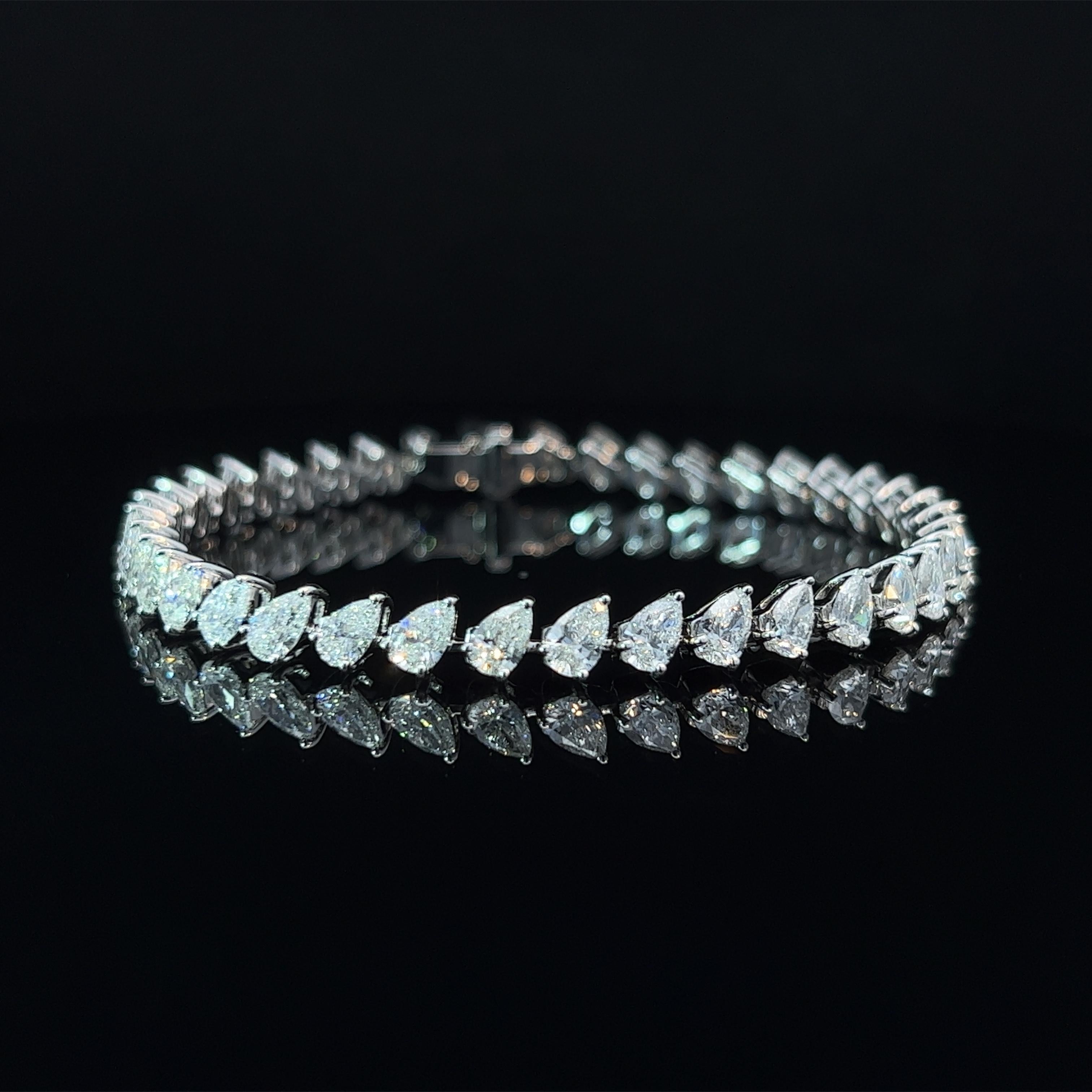 Diamond Shape: Pear Cut  
Total Diamond Weight: 9.45ct
Individual Diamond Weight: .25ct
Color/Clarity: FG VS  
Metal: 18K White Gold 
Metal Weight: 13.58g

Key Features:

Pear-Cut Diamonds: The centerpiece of this bracelet consists of a series of