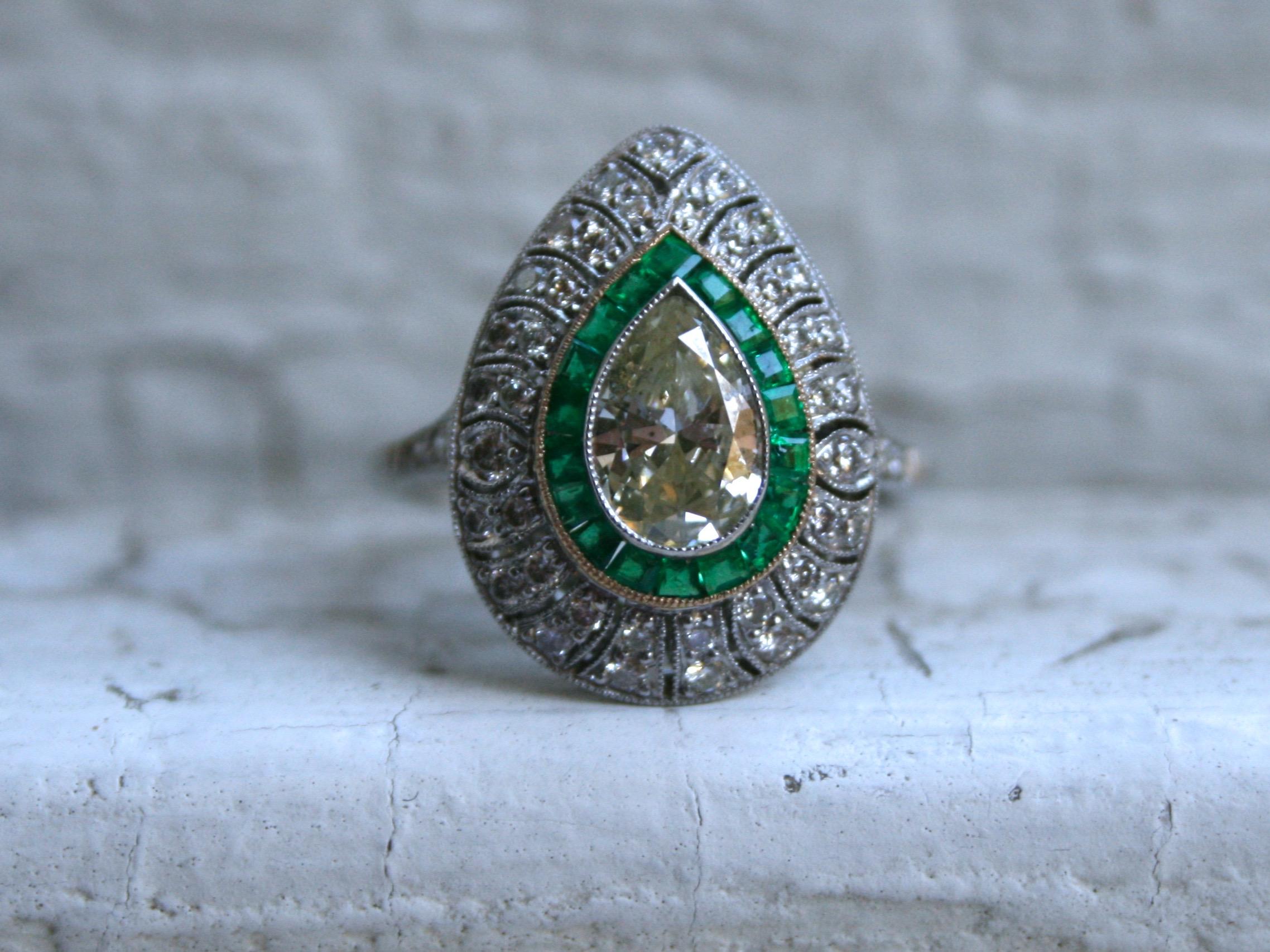 Oh my goodness this Stunning Pear Cut Diamond and Emerald Halo Ring Engagement Ring in Platinum is GORGEOUS! It's such a detailed, elegant piece! Crafted in Platinum, the design features a beautiful Pear Cut Diamond center, surrounded by a gorgeous