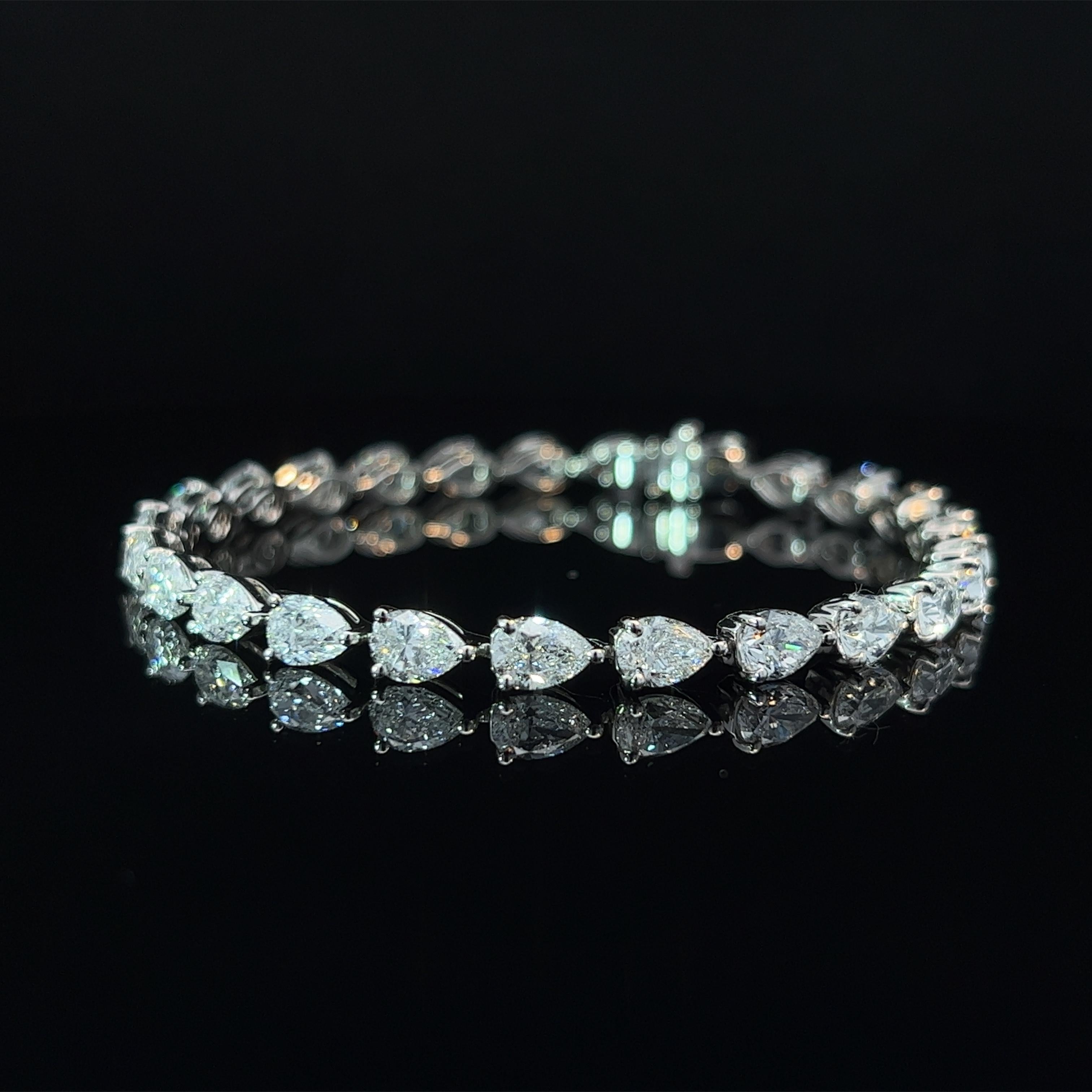 Diamond Shape: Pear Cut 
Total Diamond Weight: 12.58ct
Individual Diamond Weight: .50ct
Color/Clarity: FG VVS  
Metal: PT950  
Metal Weight: 15.52g 

Key Features:

Pear-Cut Diamonds: The centerpiece of this bracelet showcases a dazzling array of