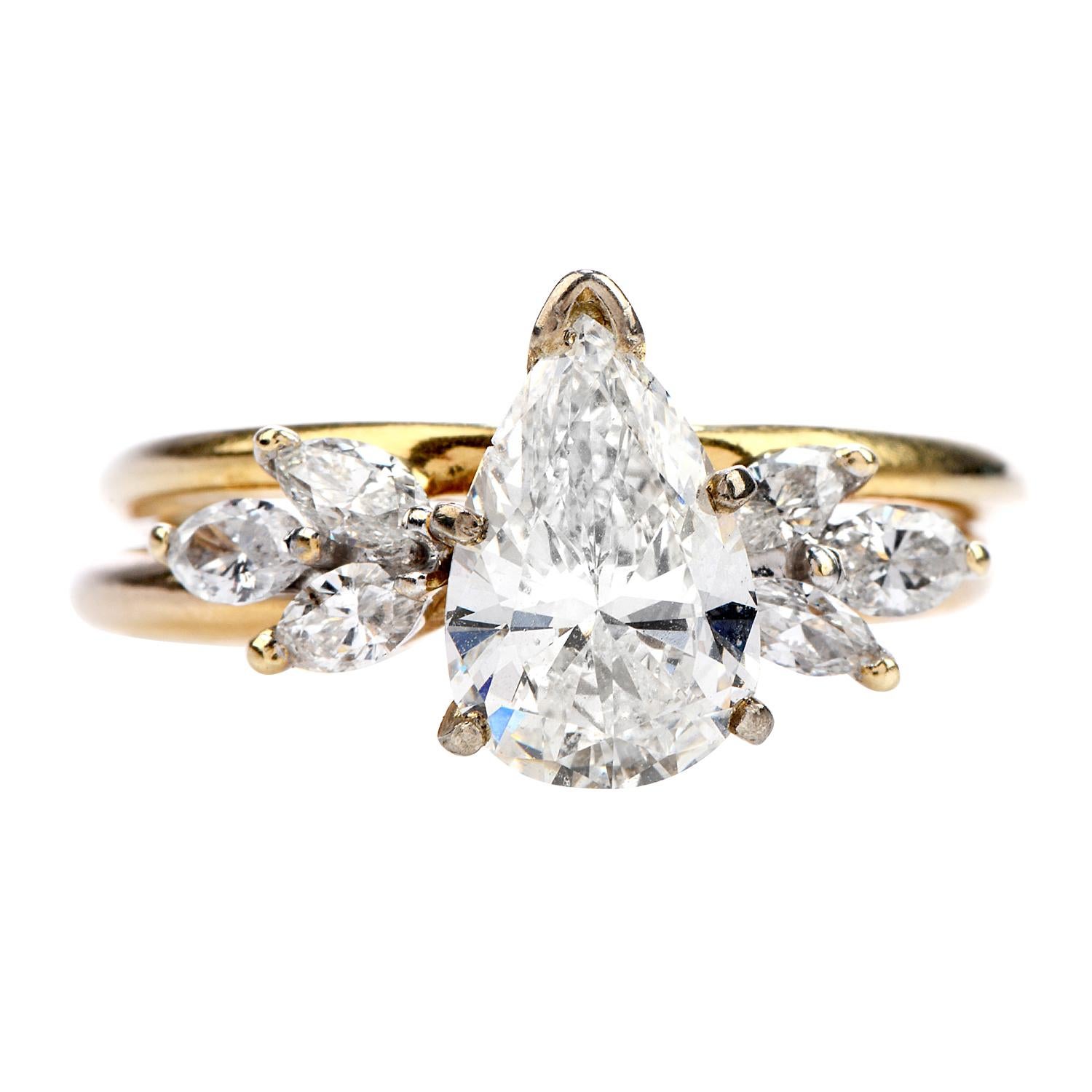 This Bridal Set is the perfect combination between Classic and Sparkle!

Both rings on this piece are crafted in Solid 14K Yellow Gold,

Prominently featuring a center Pear-cut Diamond of an approximately1.42 carats, I color and SI2 clarity ( 1