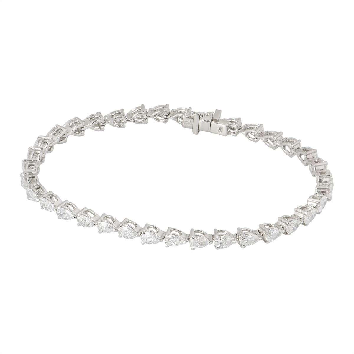 An elegant 18k white gold diamond line bracelet. The bracelet is made up of 35 claw set pear cut diamonds totalling 3.97ct. The diamonds are predominantly G/H colour and VS+ clarity. The bracelet has a tongue clasp with an additional snap clasp