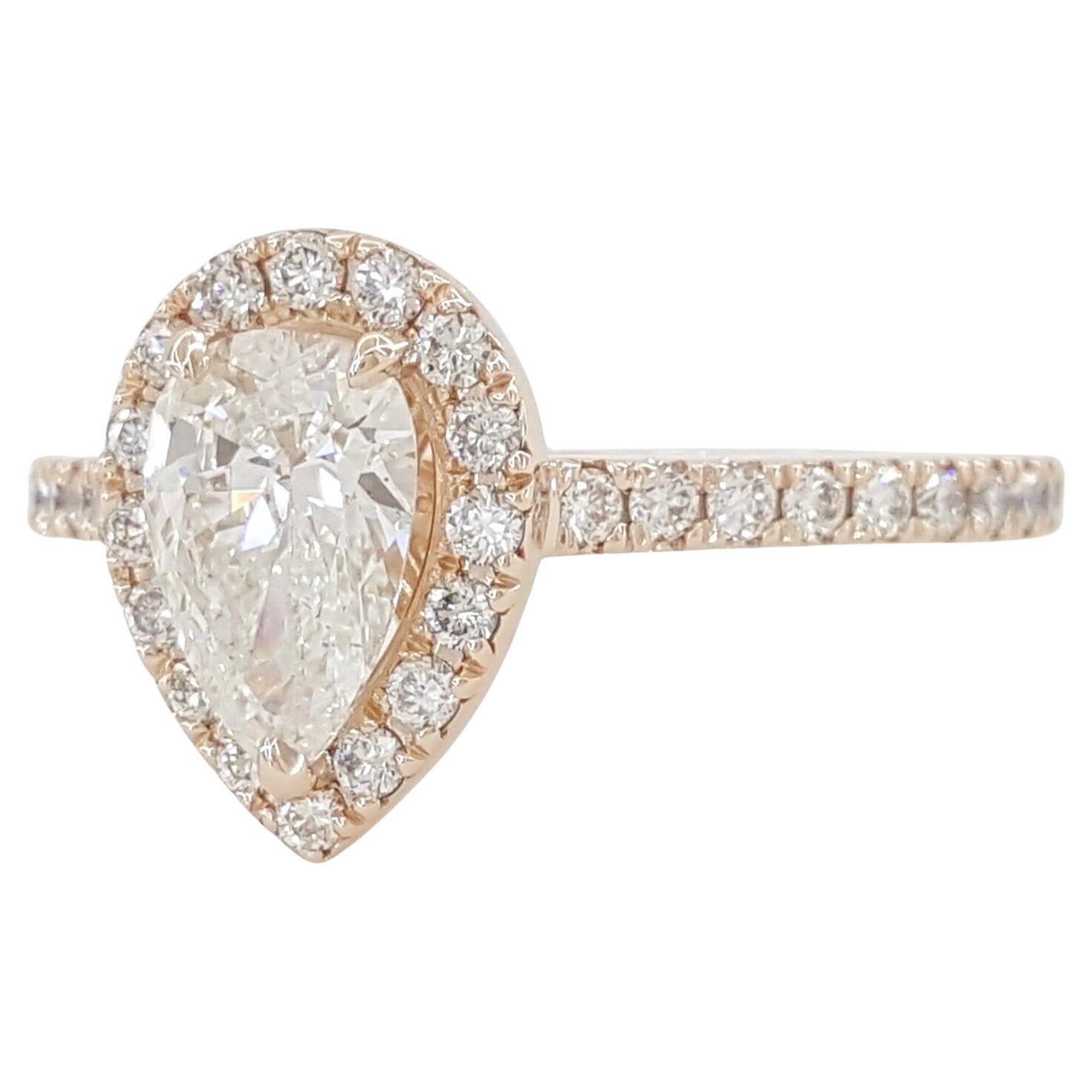 engagement ring with some specific details. Here's a breakdown of the components:

Center Stone:

Natural Pear Brilliant Cut Diamond
Weight: 0.70 carats
Color: H-I
Clarity: SI3
Halo Stones:

40 Natural Round Brilliant Cut Diamonds
Total Weight: 0.38