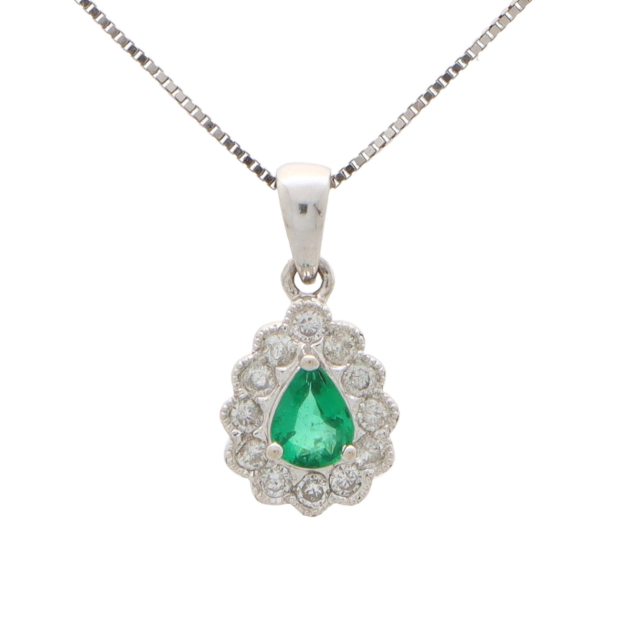 A beautiful pear cut emerald and diamond cluster pendant set in 18k white gold.

The pendant is centrally set with a beautiful coloured vibrant green pear cut emerald which is surrounded by 12 sparkly round brilliant cut diamonds. The pendant hangs