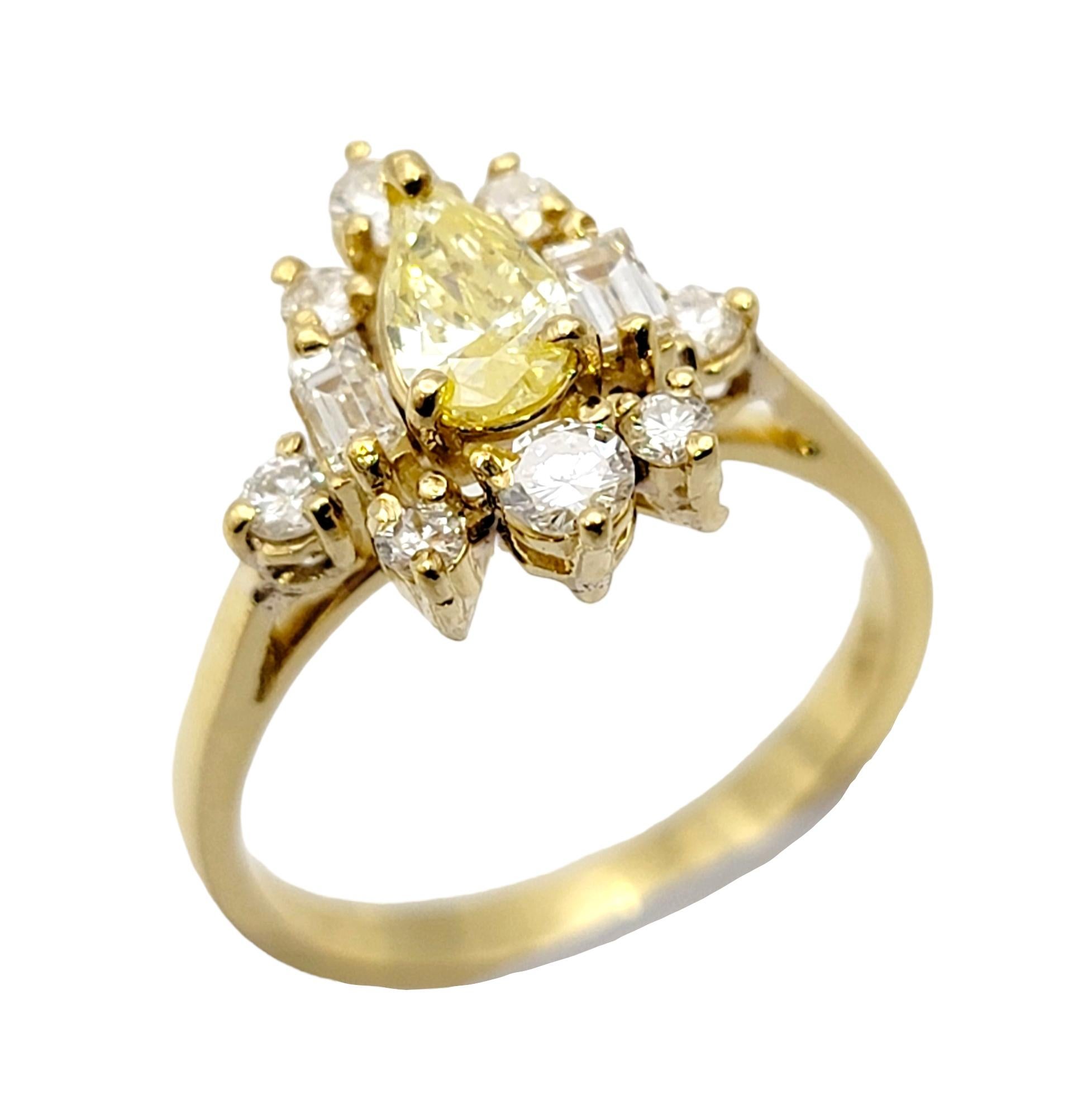 Contemporary Pear Cut Fancy Yellow Diamond Ring with White Diamond Accents 18 Karat Gold Band For Sale