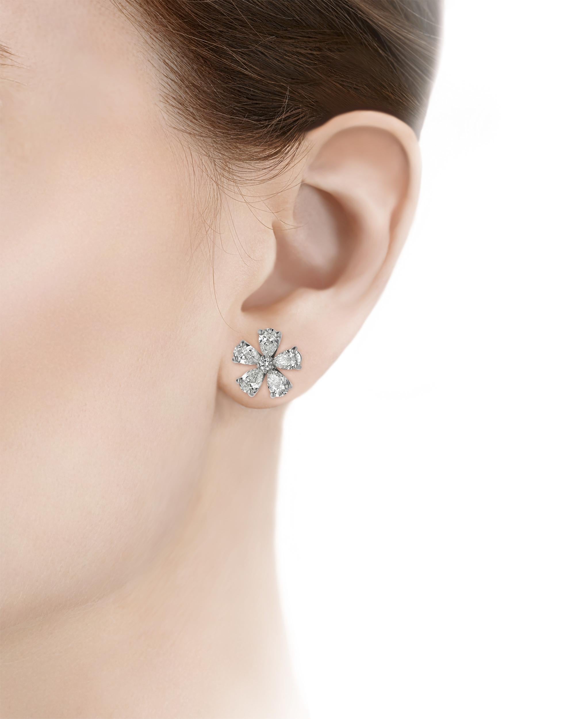 These timelessly elegant diamond earrings each feature five pear-cut diamonds arranged in a floral pattern. With a total weight of 5.08 carats, each one of these ten pear-cut diamonds is certified by the Gemological Institute of America for their