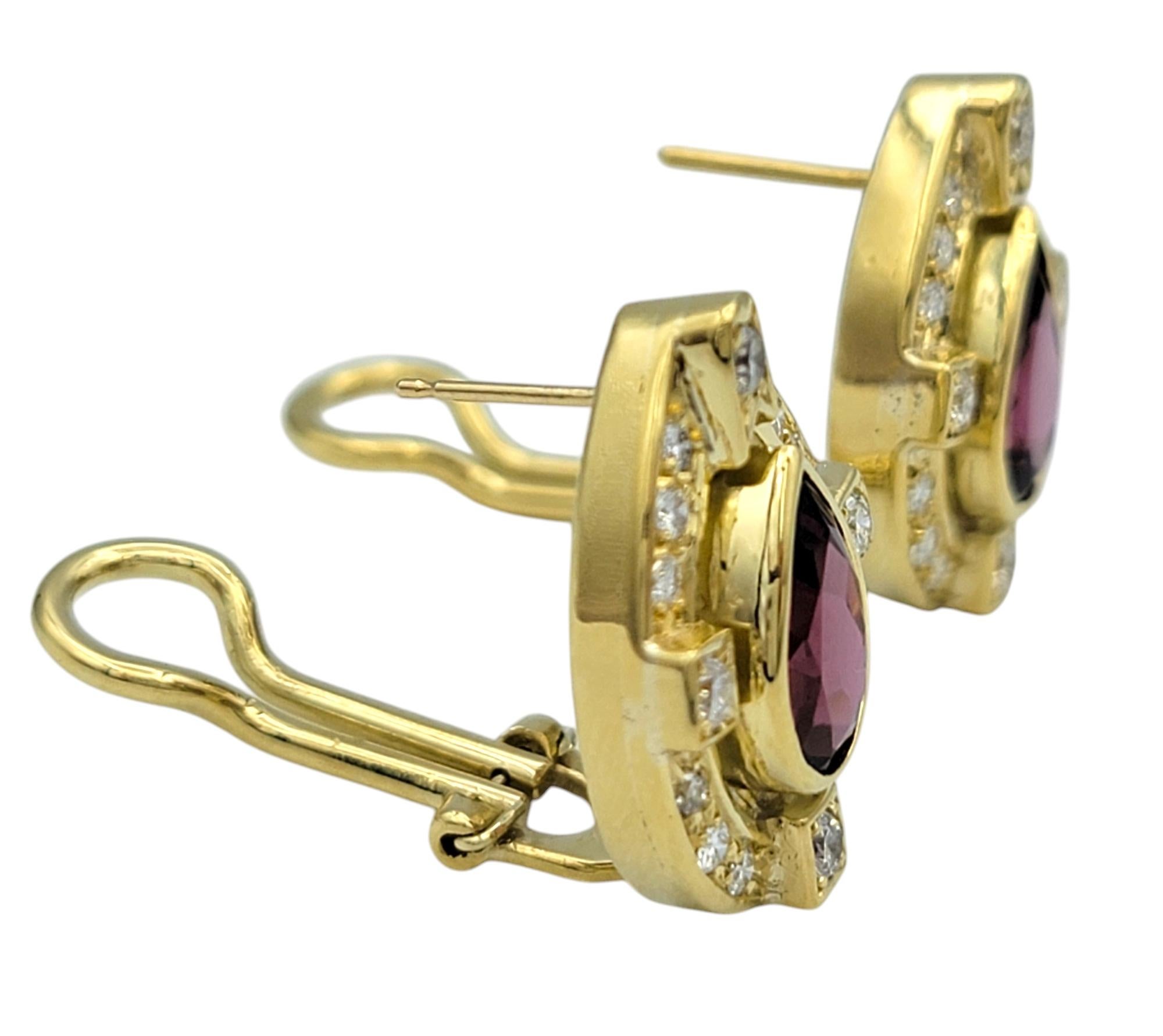 These exquisite earrings feature rich pear-shaped garnets framed by a radiant array of round-cut diamonds, all set in luxurious 18 karat yellow gold. The deep red hue of the garnets is beautifully complemented by the brilliance of the diamonds,