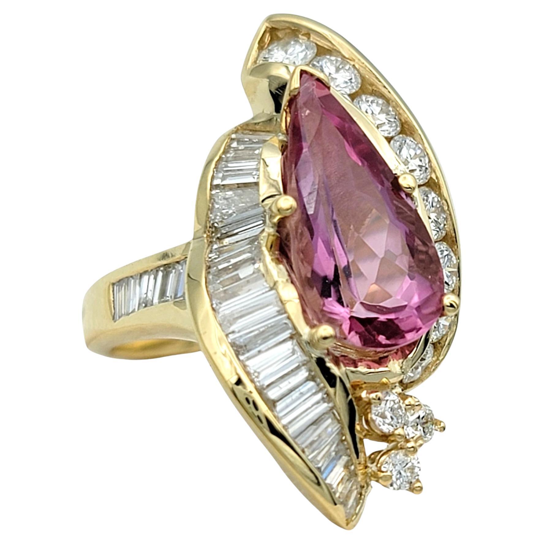 Ring Size: 7 

Indulge in the striking allure of this exceptional ring, where an elongated pear cut imperial topaz reigns supreme. Its deep, rare shade of dark pink casts a warm, captivating glow, set off exquisitely by the radiant tones of 14 karat