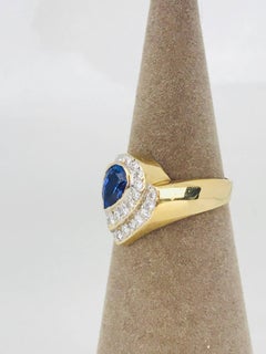 Pear Deep Blue Colored Tanzanite, Art Nouveau Style Ring with Pave Set Diamonds